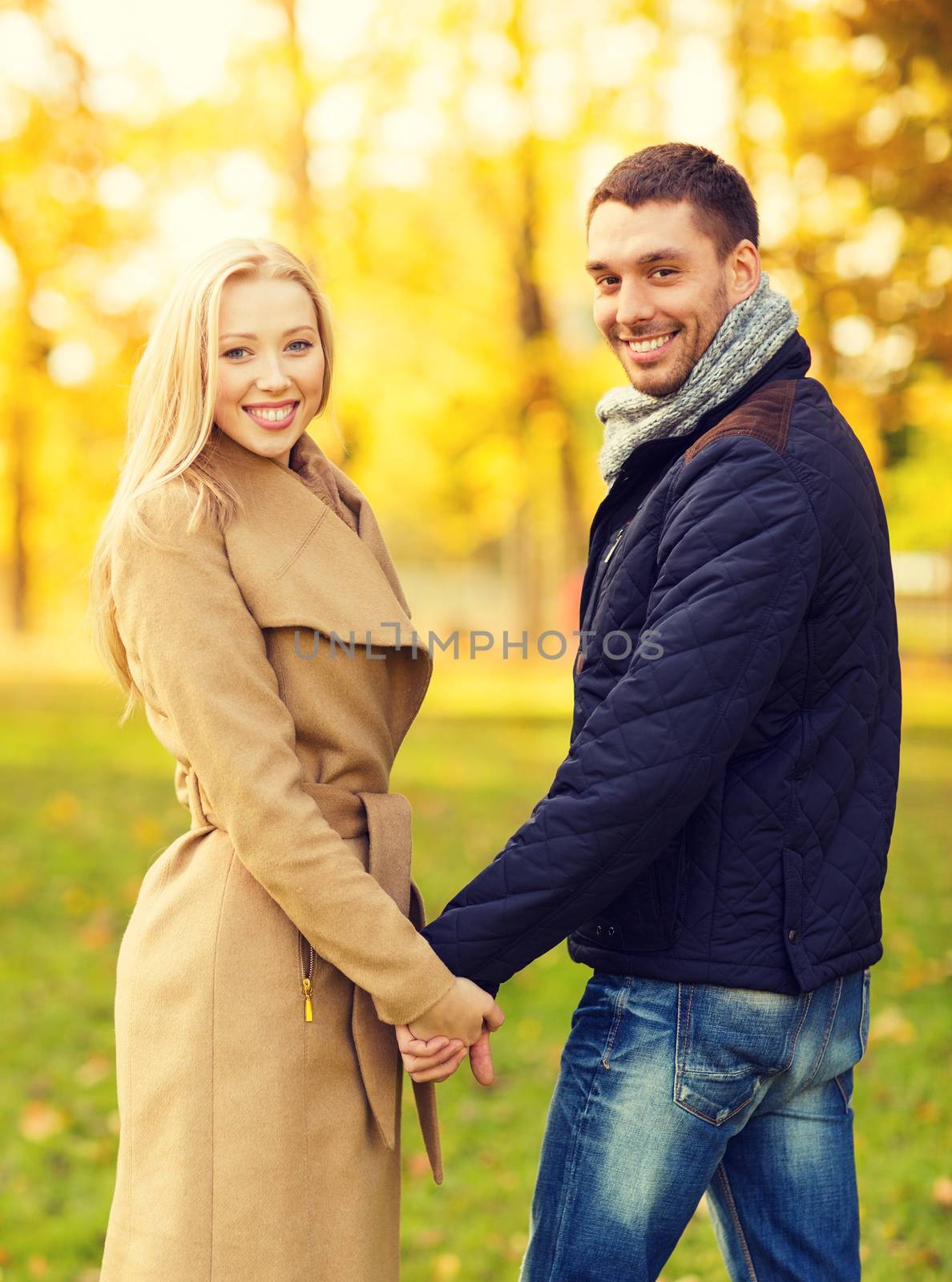 holidays, love, travel, relationship and dating concept - romantic couple in the autumn park