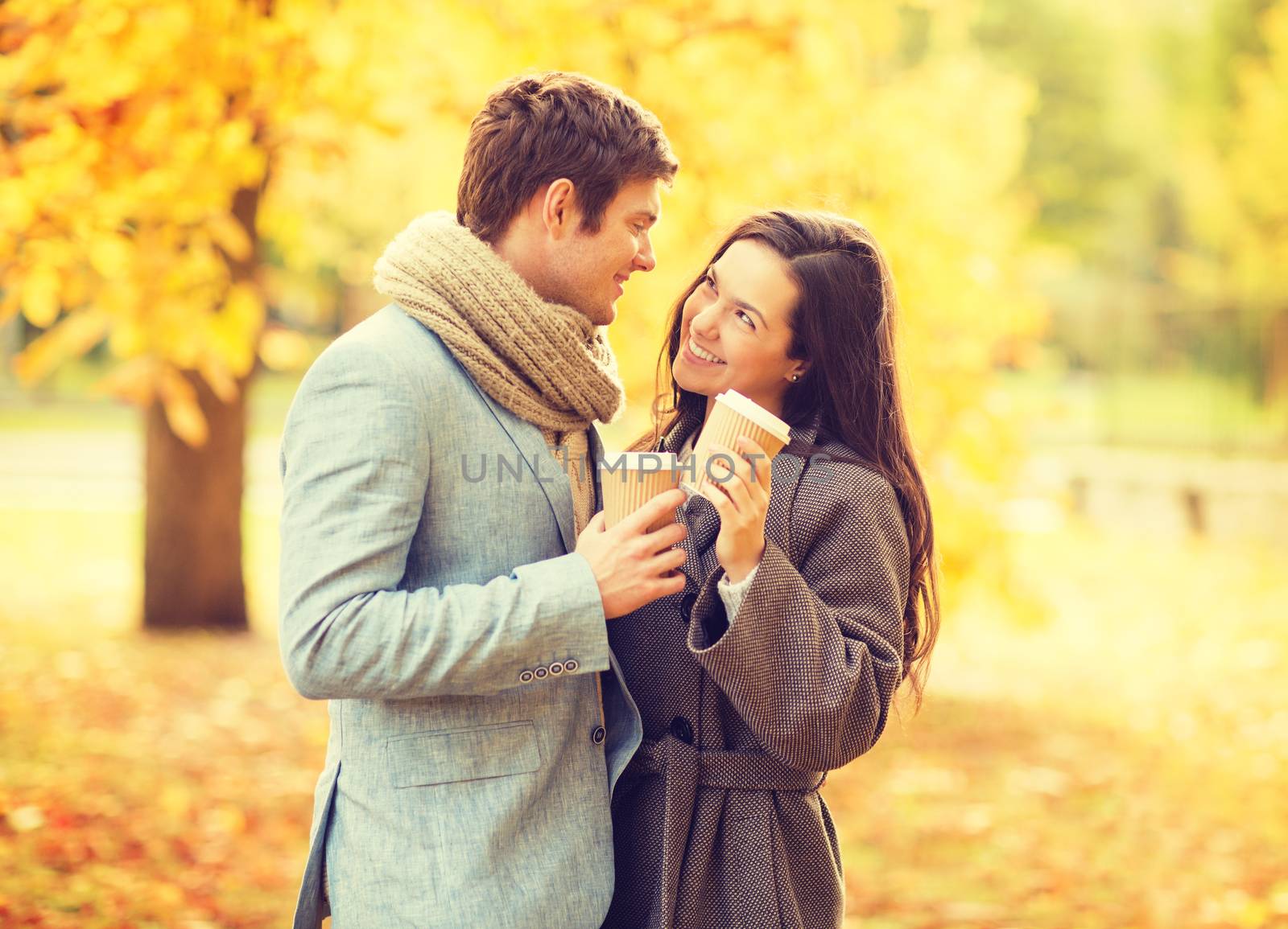 holidays, love, travel, relationship and dating concept - romantic couple in the autumn park