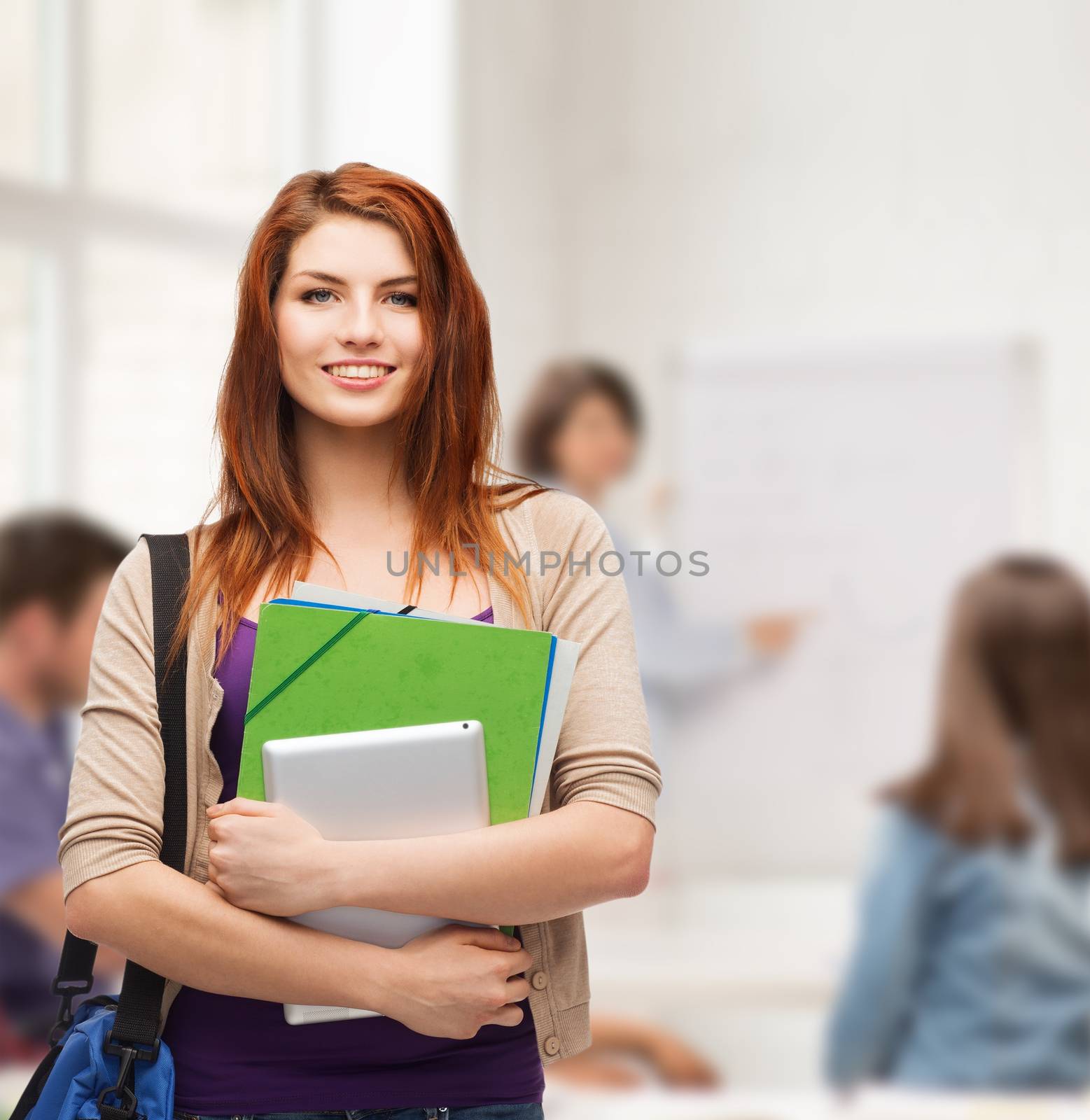 smiling student with bag, folders and tablet pc by dolgachov