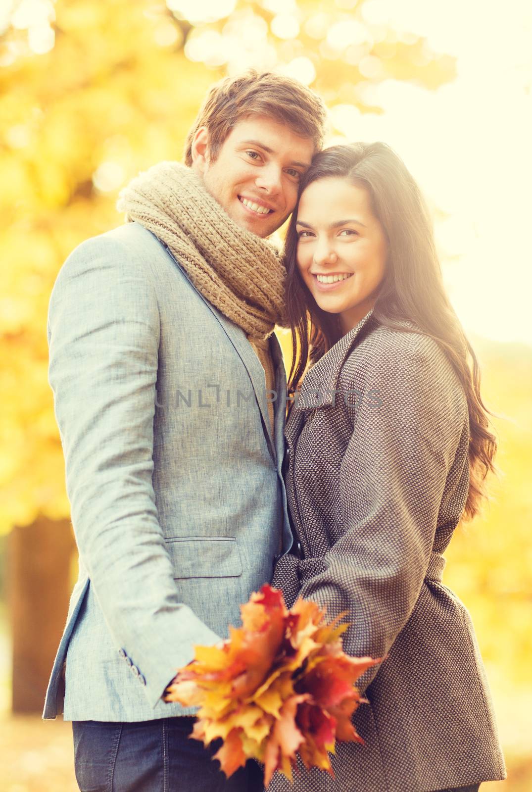 romantic couple in the autumn park by dolgachov