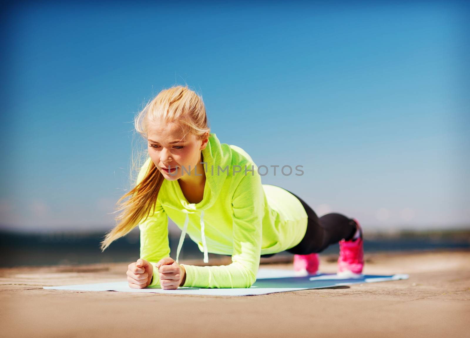 woman doing sports outdoors by dolgachov