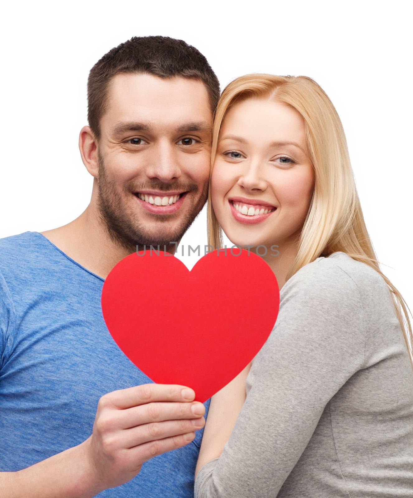 smiling couple holding big red heart by dolgachov