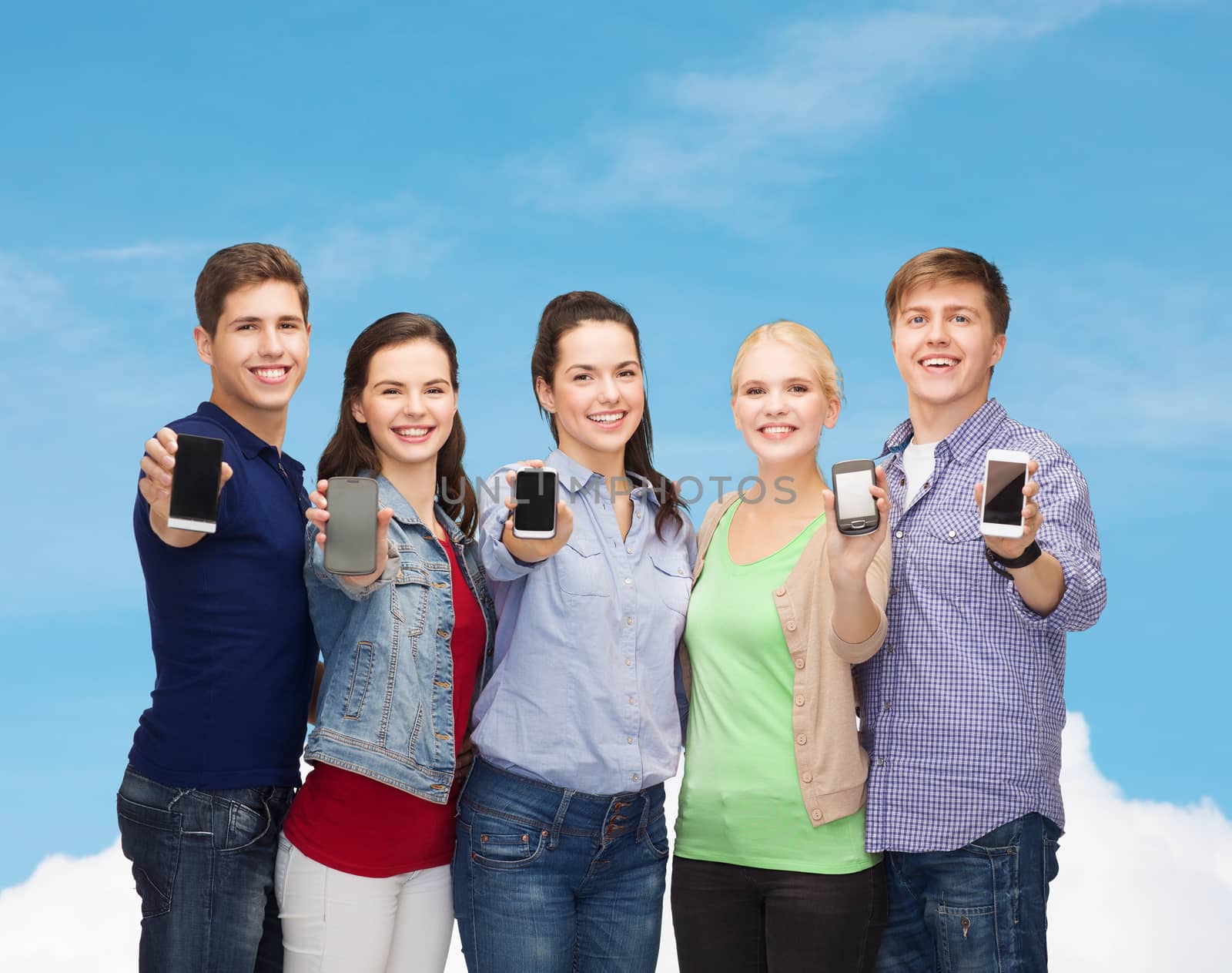 students showing blank smartphones screens by dolgachov