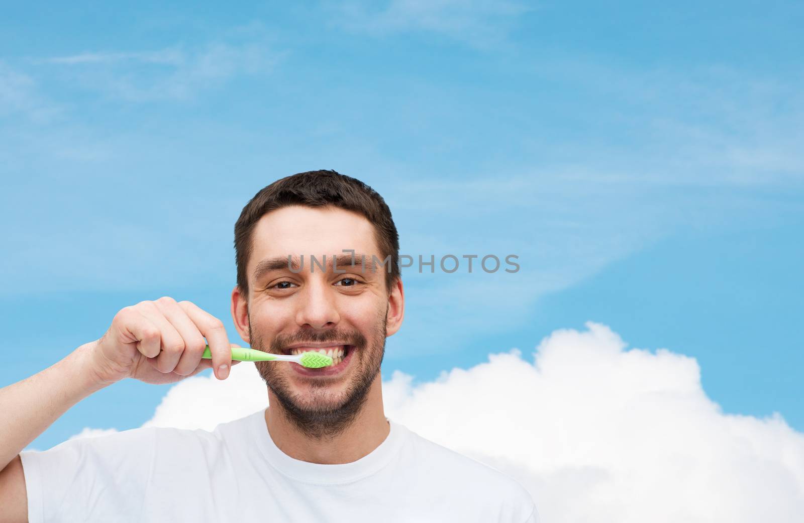 health and beauty concept - smiling young man with toothbrush