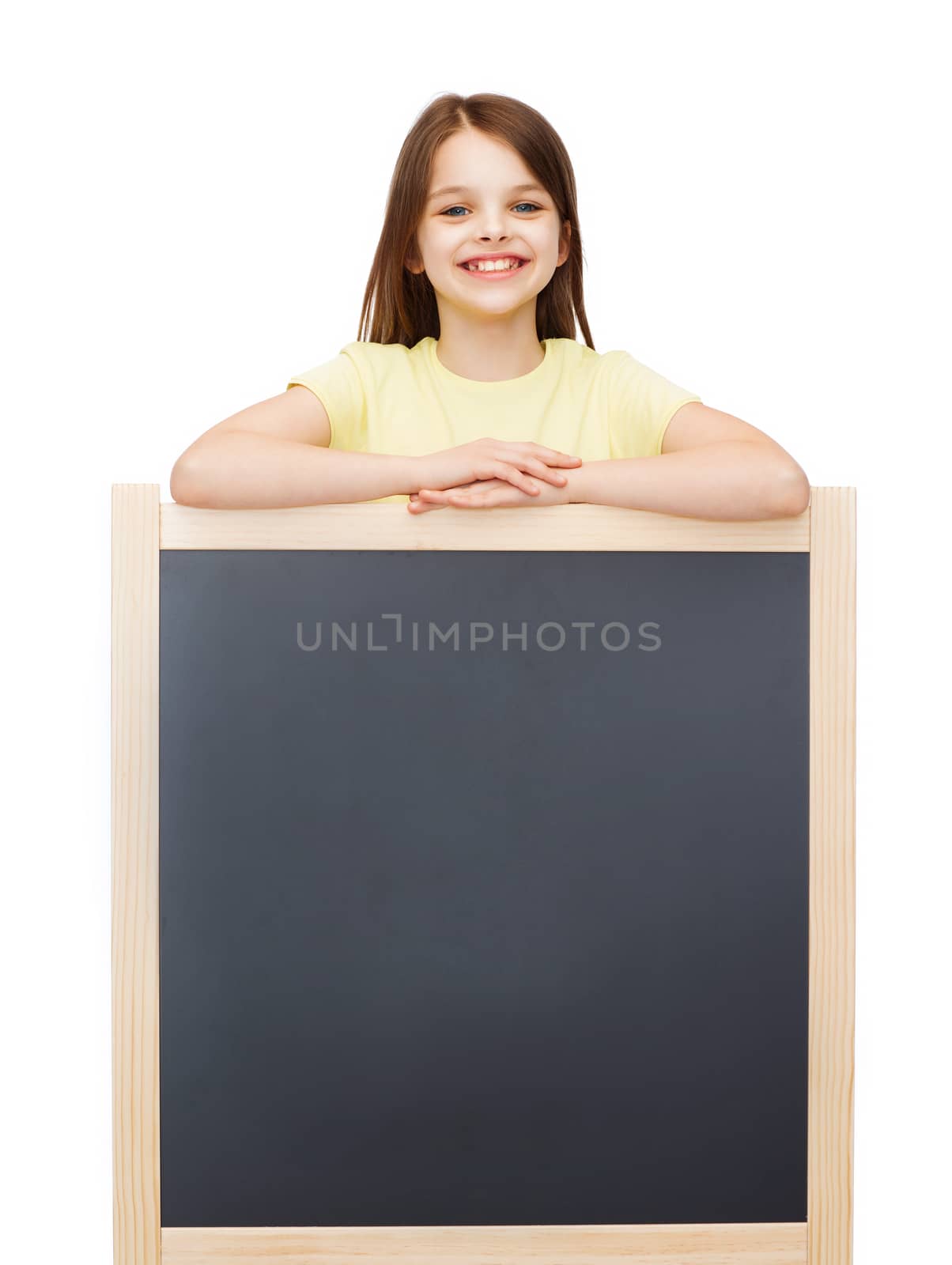 people, advertisement and education concept - happy little girl with blank blackboard