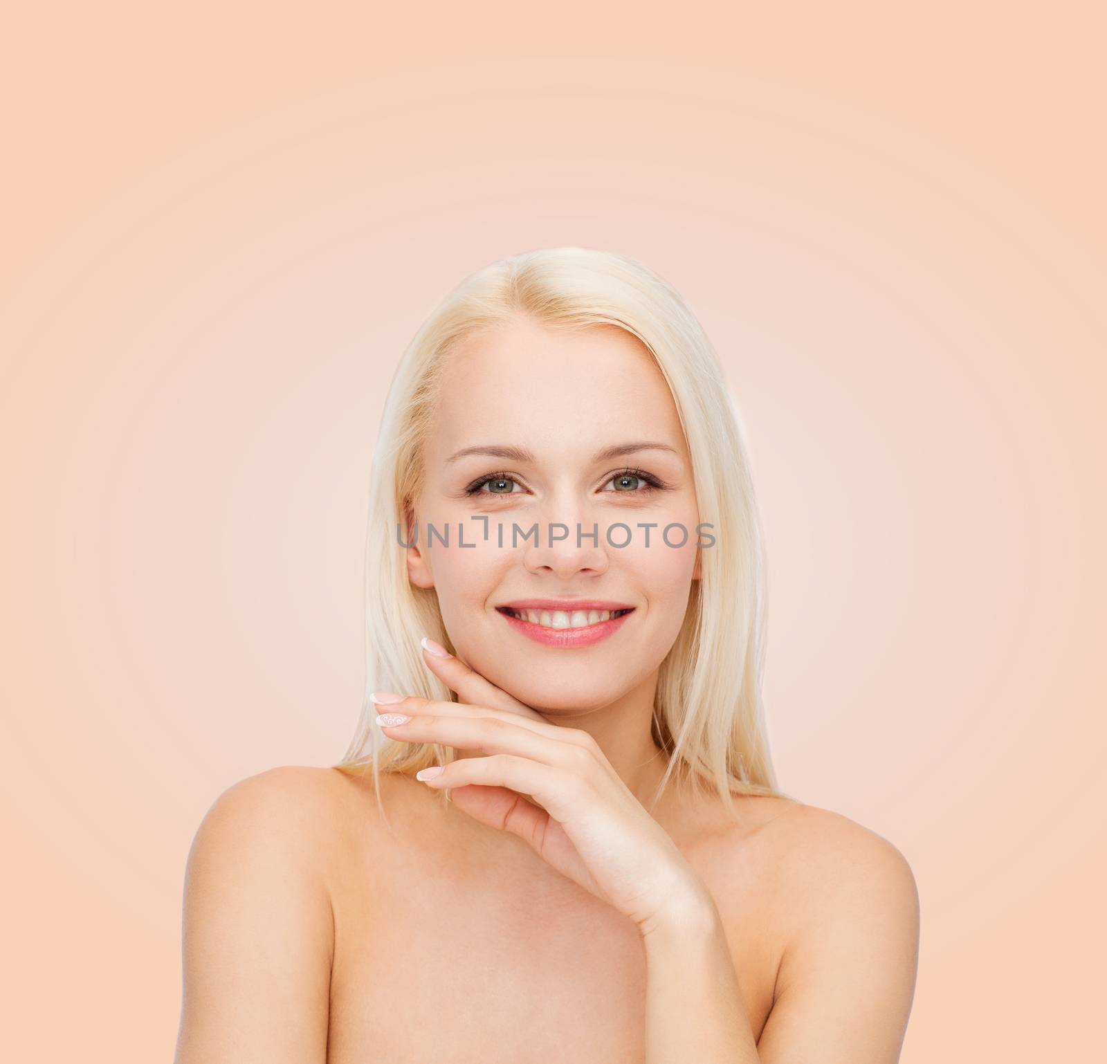health and beauty concept - face and hands of beautiful woman