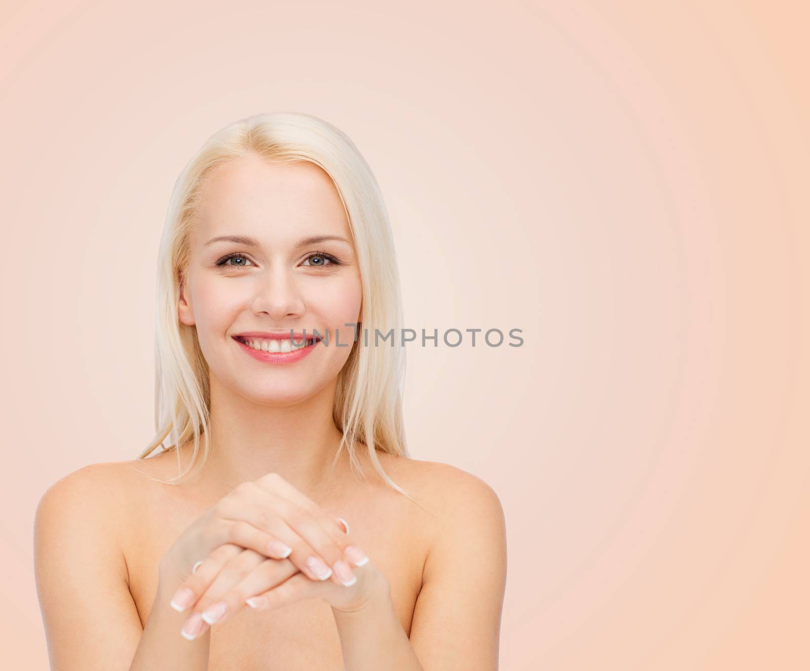 health and beauty concept - face and hands of beautiful woman