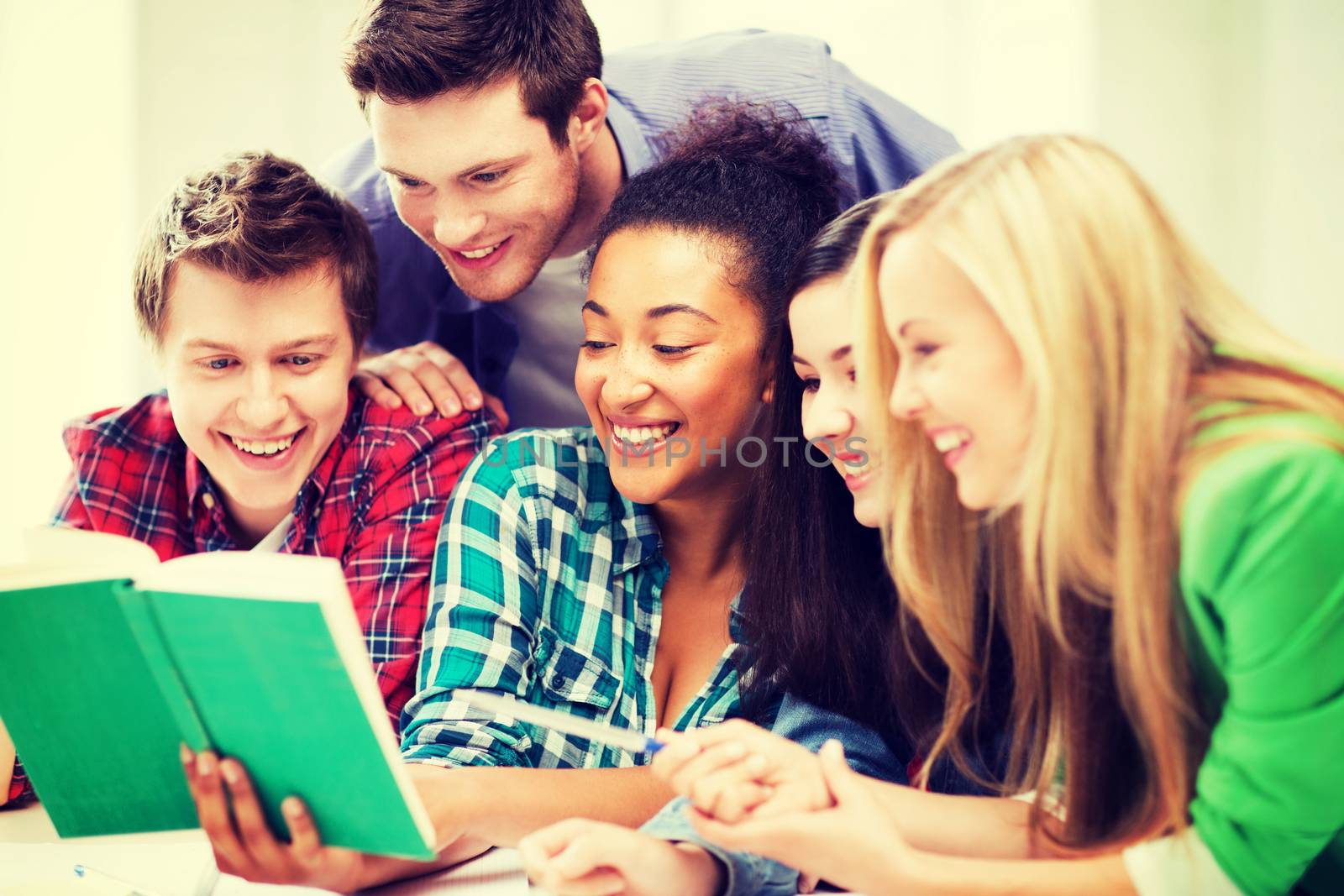 education concept - group of students reading book at school