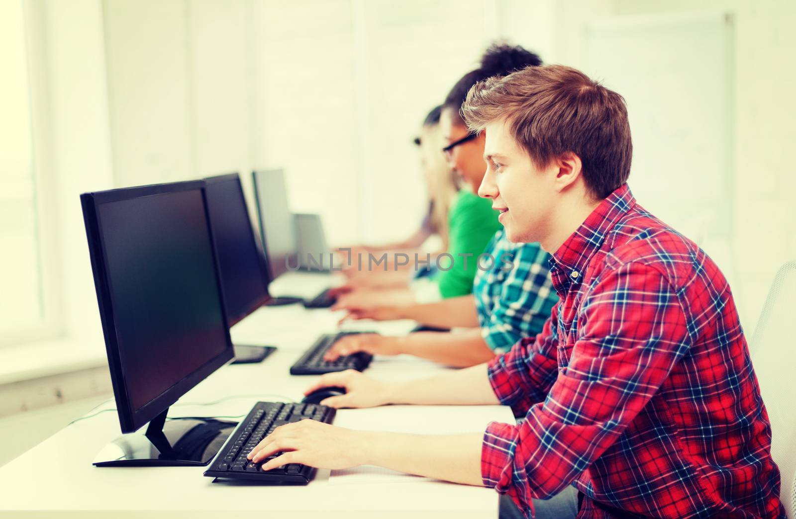 student with computer studying at school by dolgachov