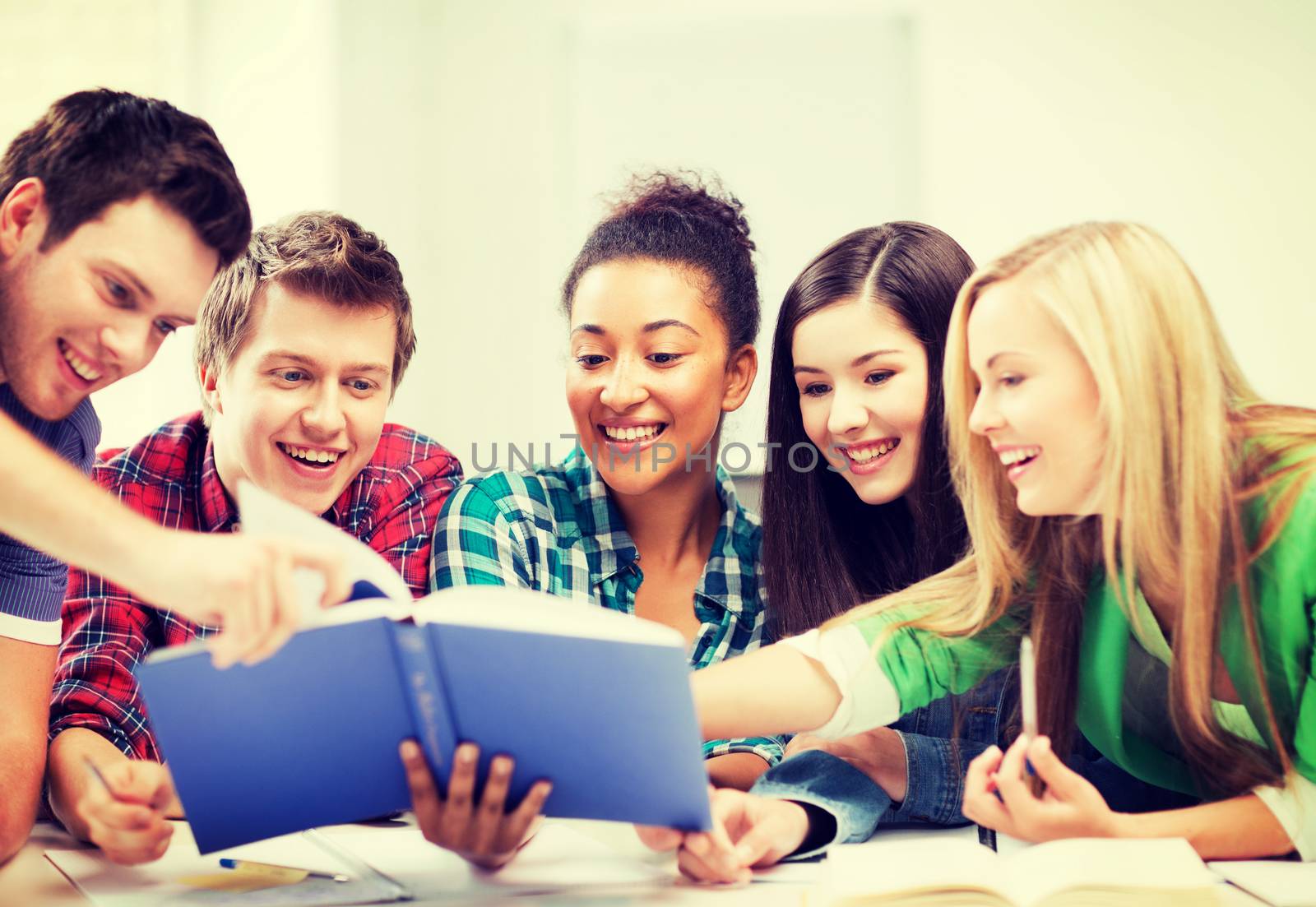 students reading book at school by dolgachov