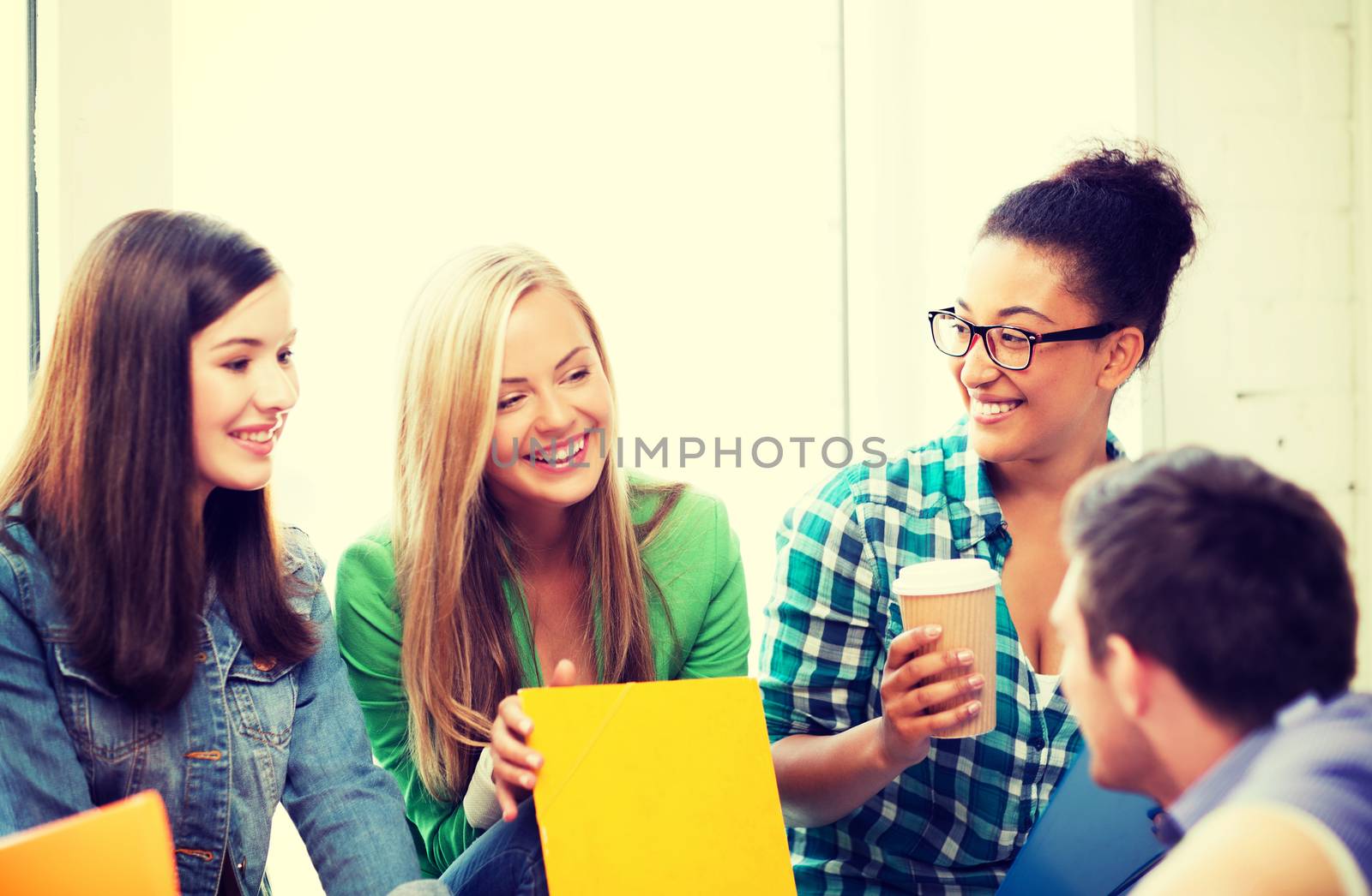 students communicating and laughing at school by dolgachov