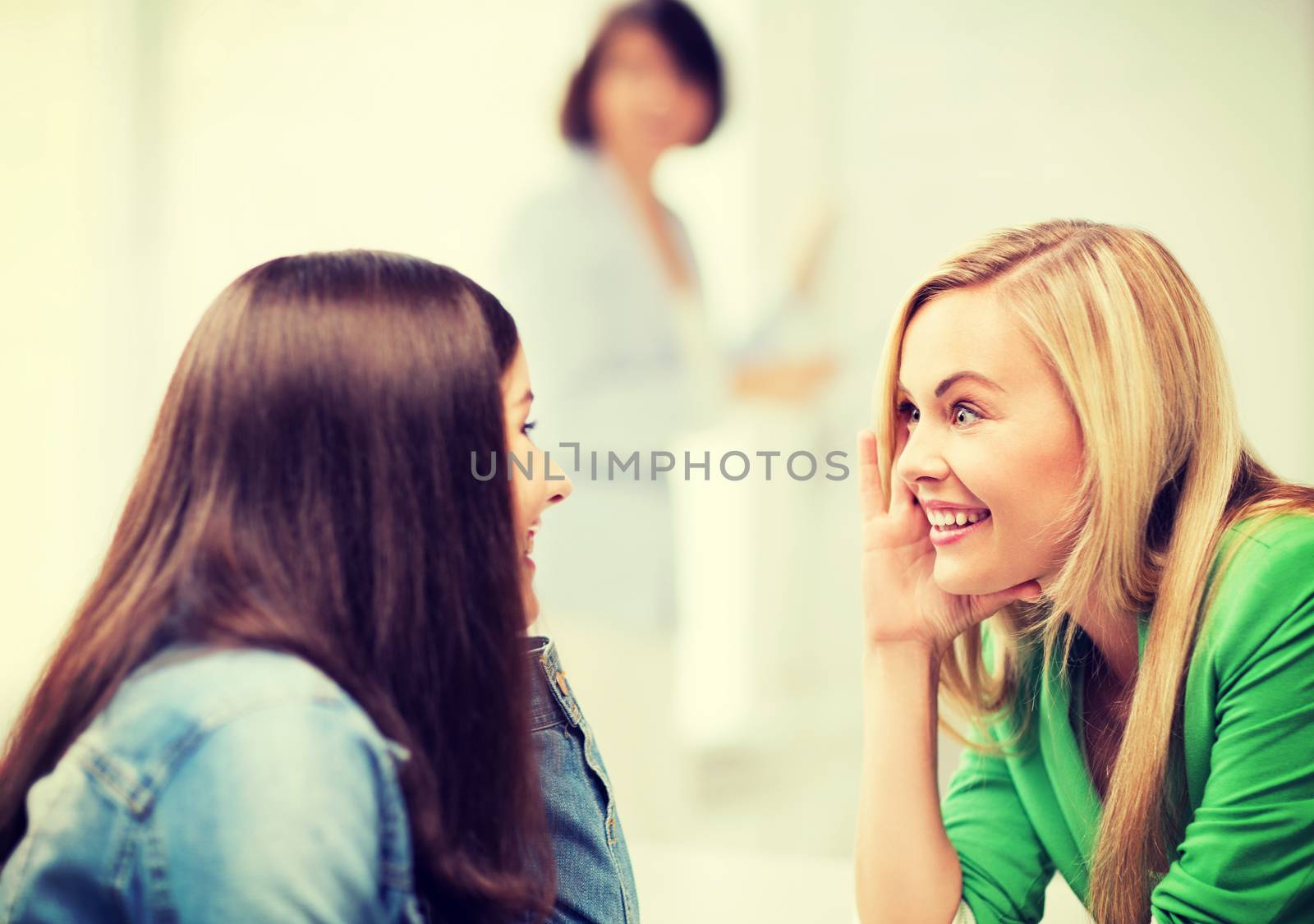 student girls gossiping at school by dolgachov