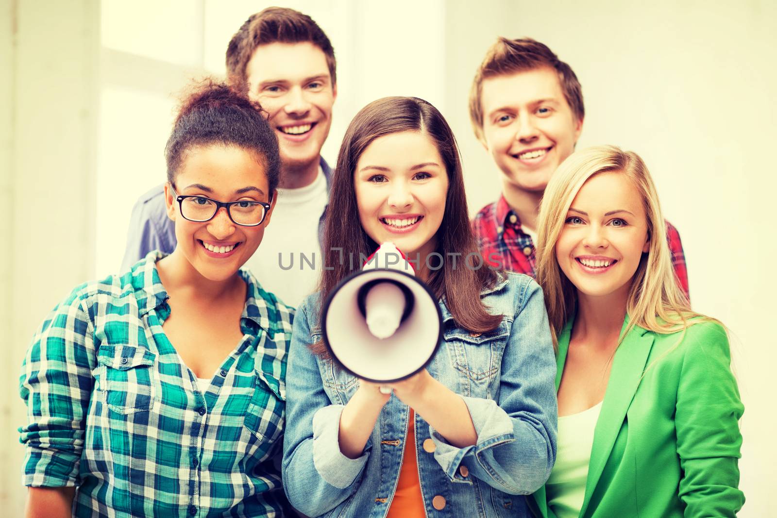 education concept - group of students with megaphone at school