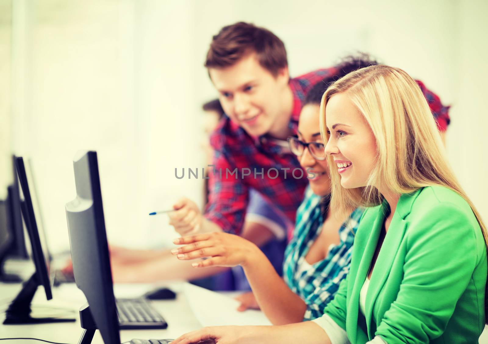 students with computer studying at school by dolgachov