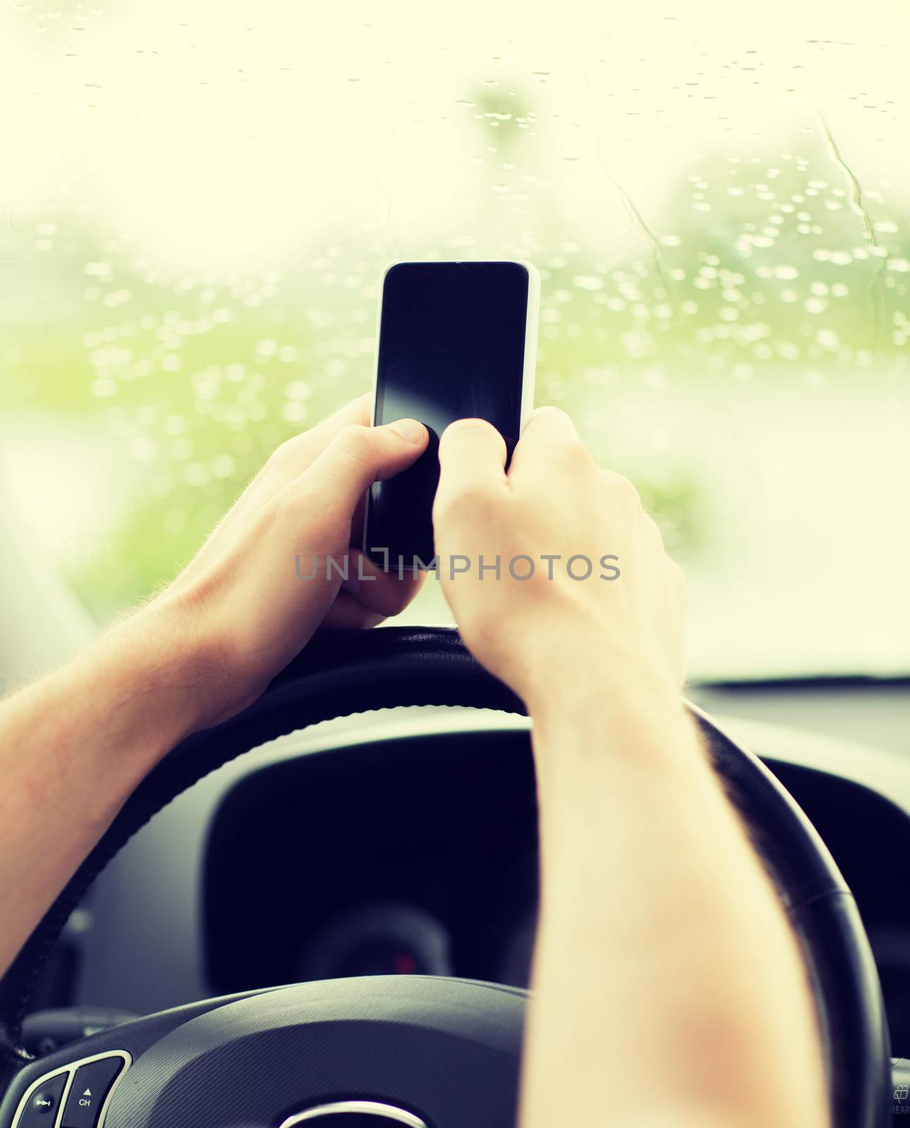 transportation and vehicle concept - man using phone while driving the car