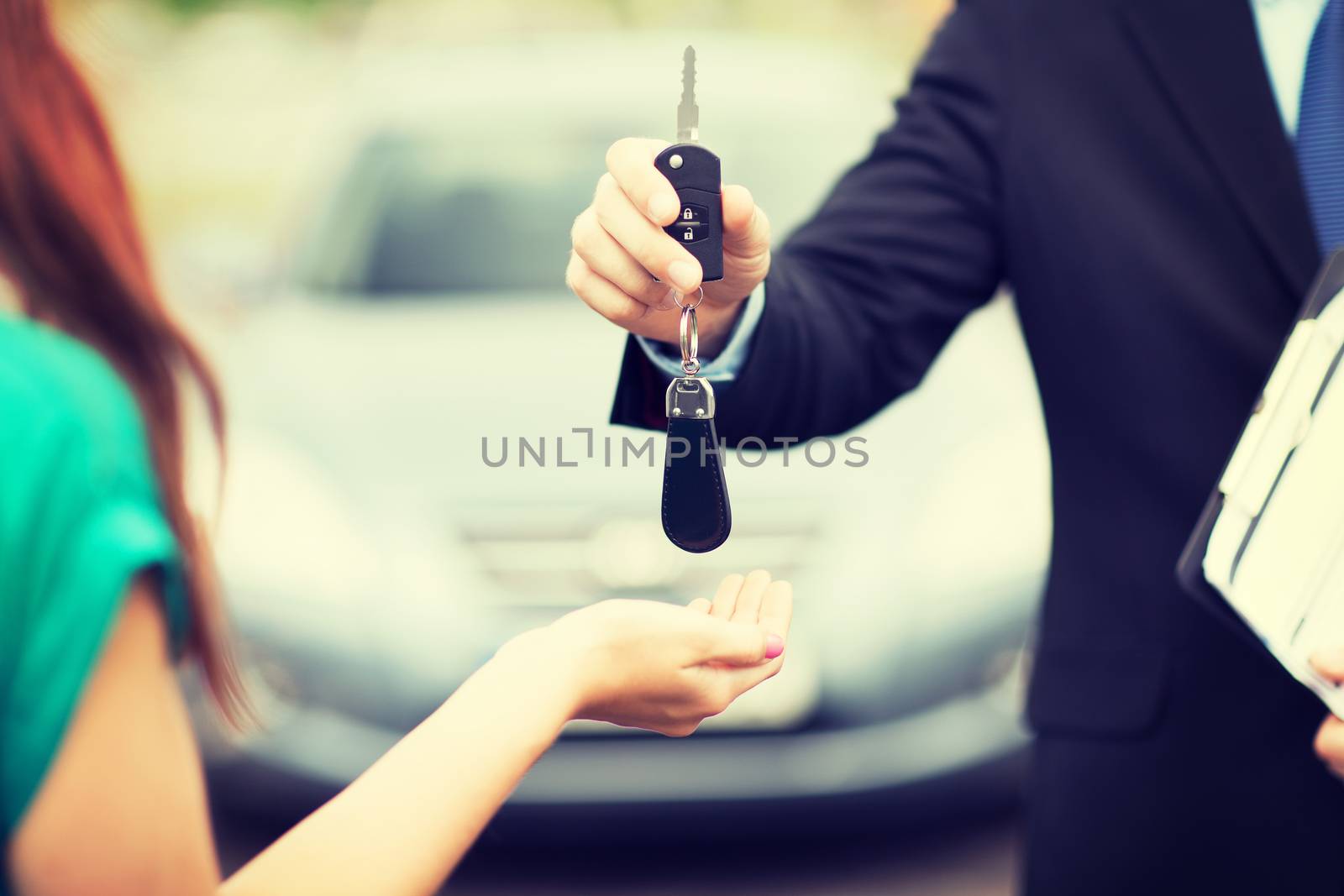 customer and salesman with car key by dolgachov