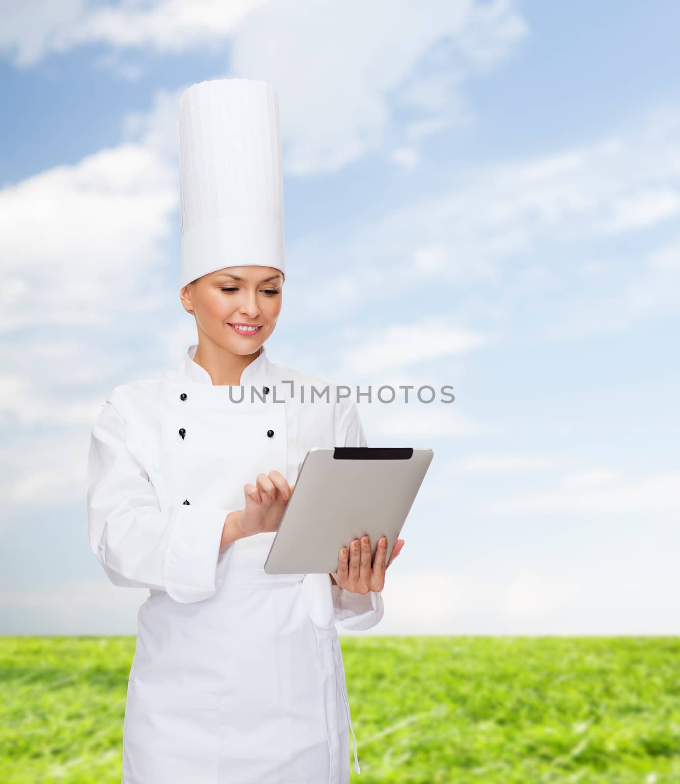 cooking, technology and food concept - smiling female chef with tablet pc computer