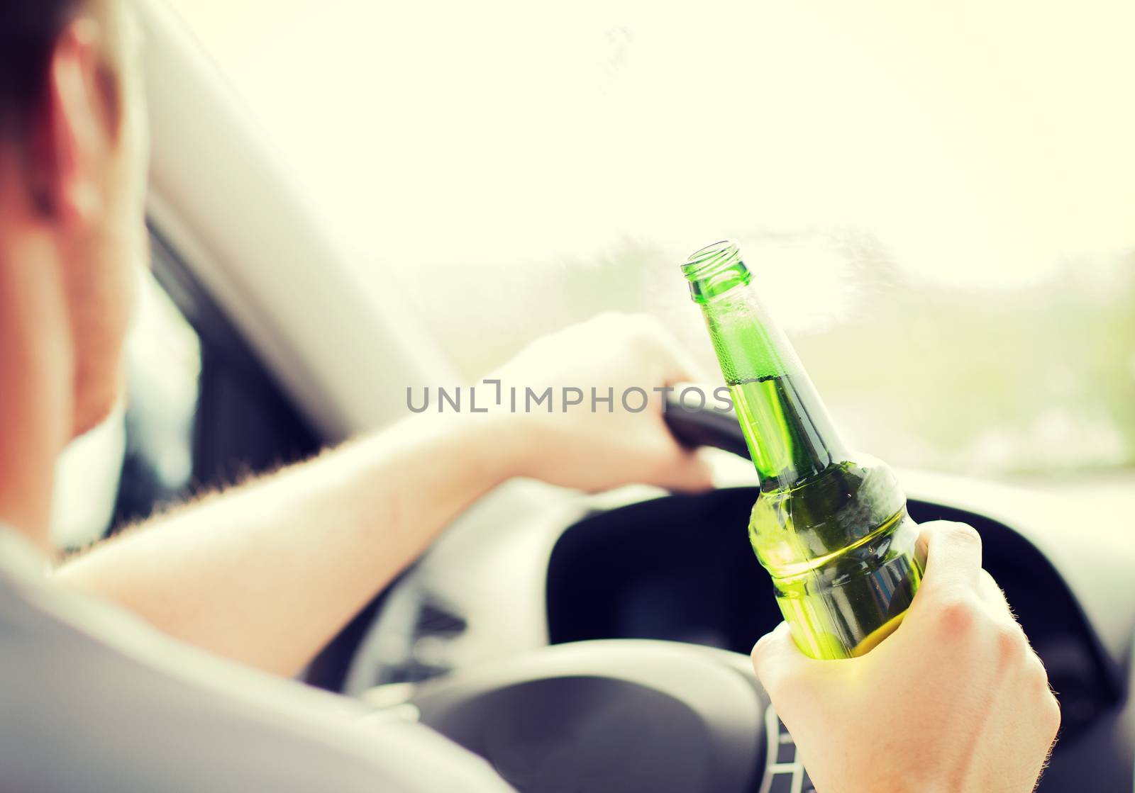 man drinking alcohol while driving the car by dolgachov