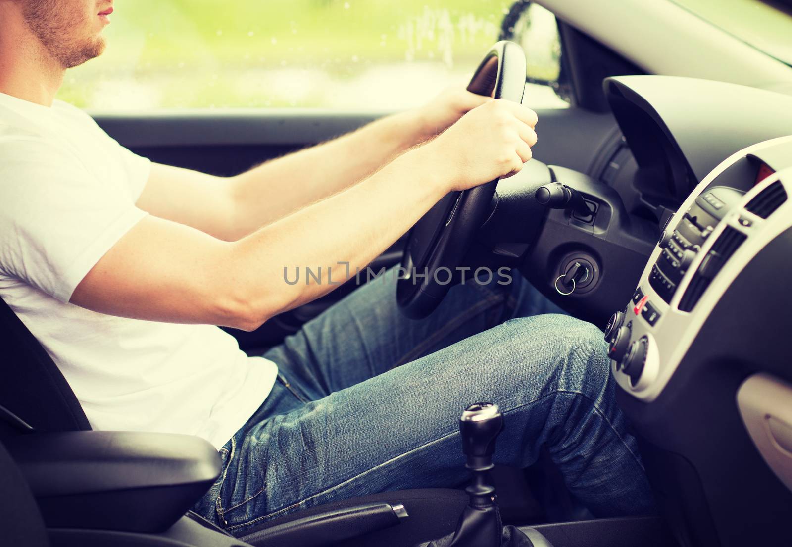 transportation and vehicle concept - man driving the car with manual gearbox