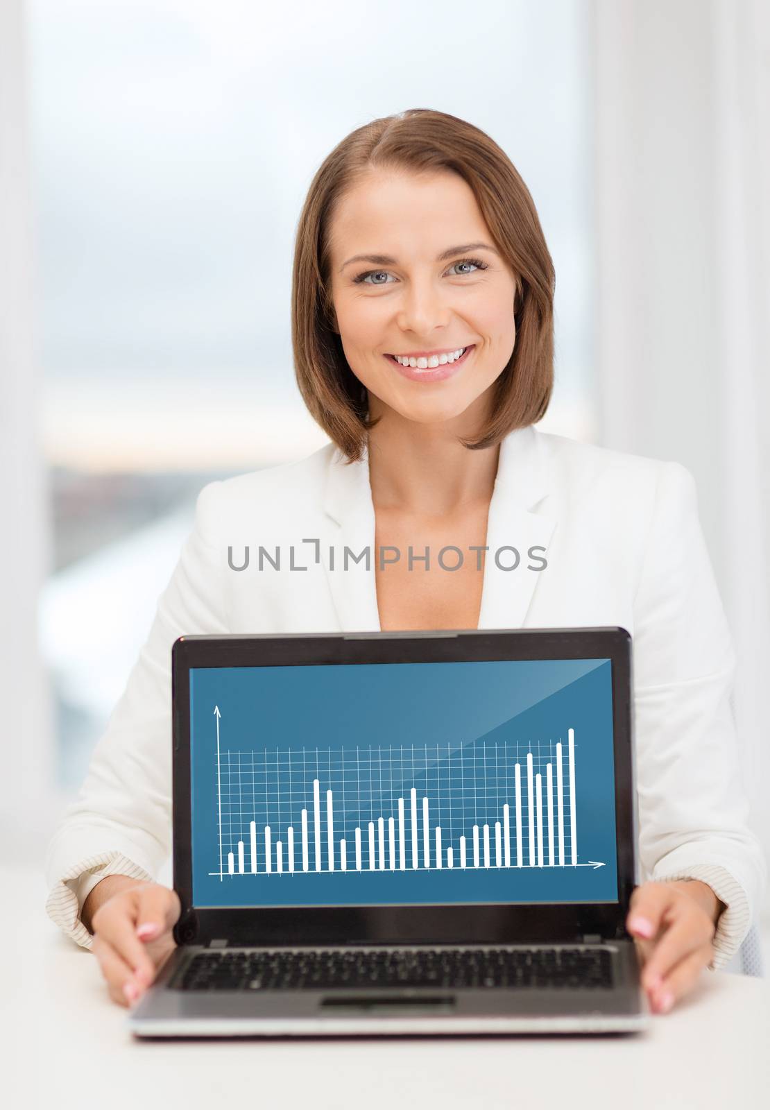 education, business, technology and internet concept - smiling woman with laptop computer in office