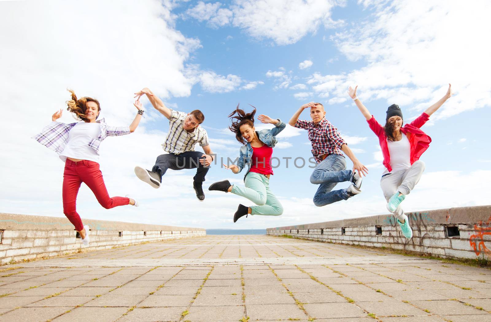 group of teenagers jumping by dolgachov
