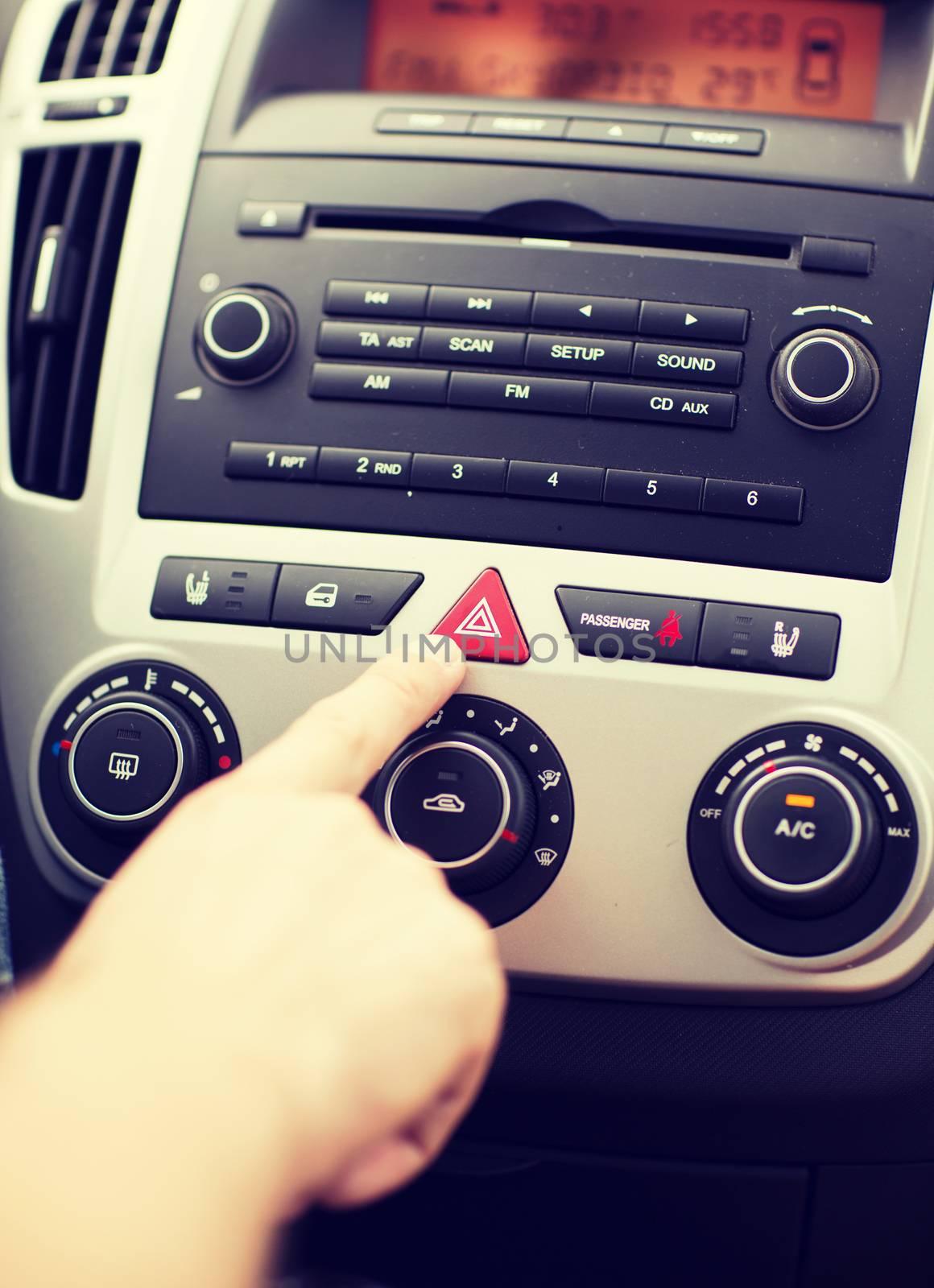 transportation and vehicle concept - man pressing red triangle car hazard warning button