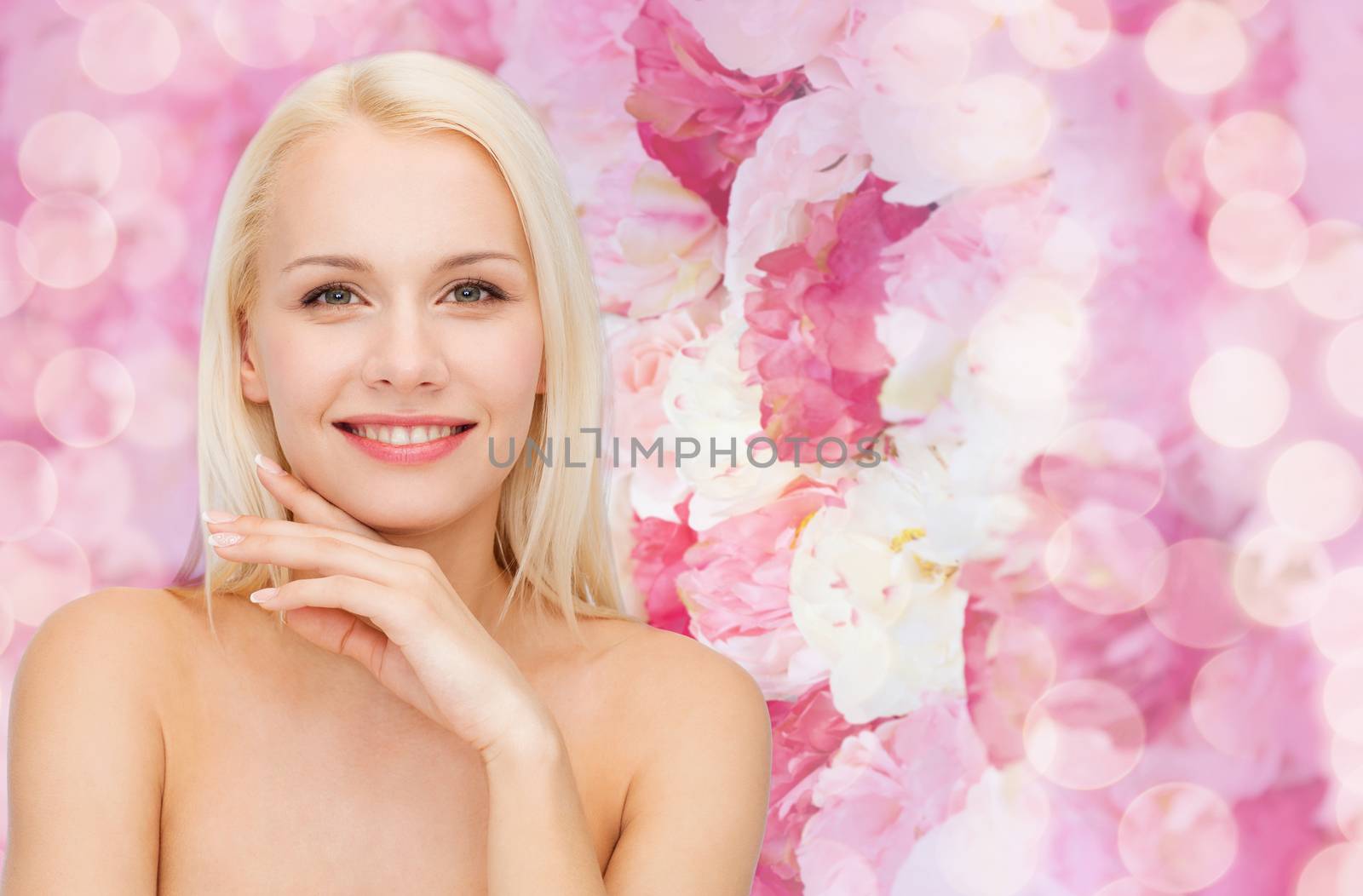 health and beauty concept - face and hands of beautiful woman
