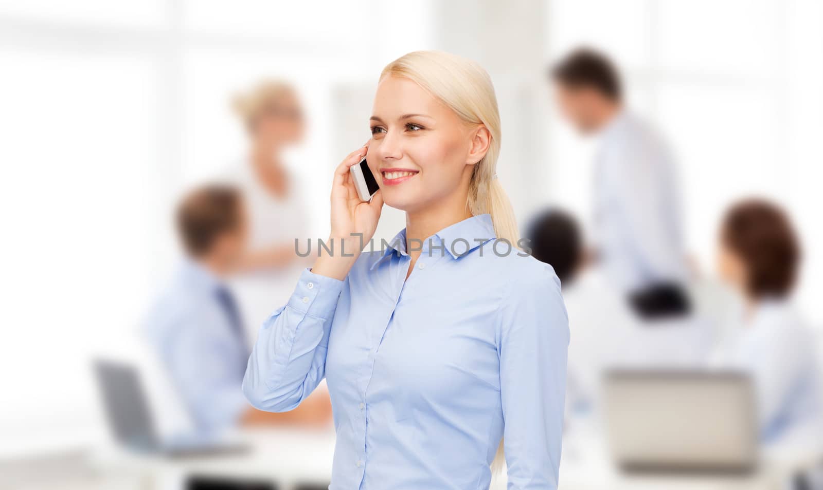 young smiling businesswoman with smartphone by dolgachov