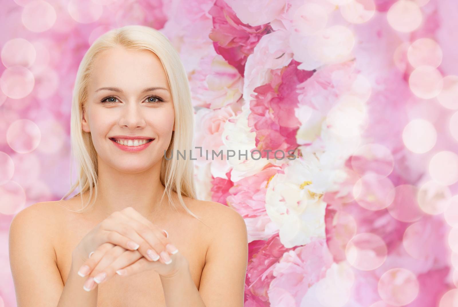 health and beauty concept - face and hands of beautiful woman