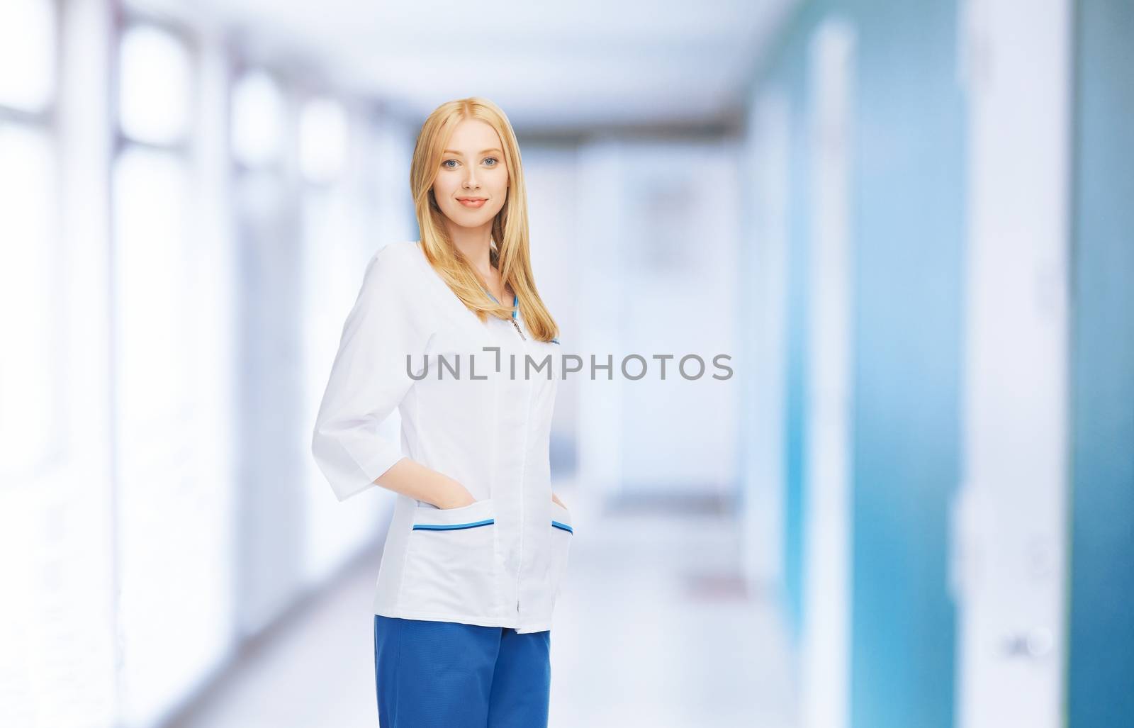 smiling female doctor or nurse in medical facility by dolgachov