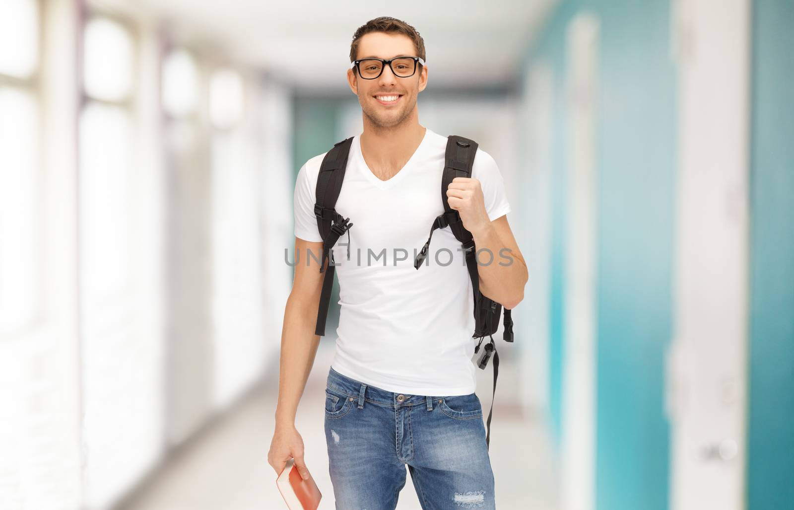 smiling student with backpack and book by dolgachov