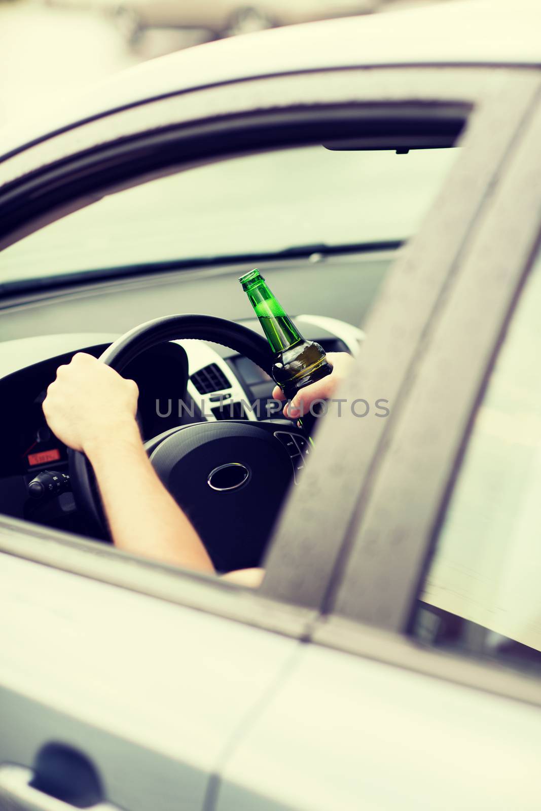 transportation and vehicle concept - man drinking alcohol while driving the car