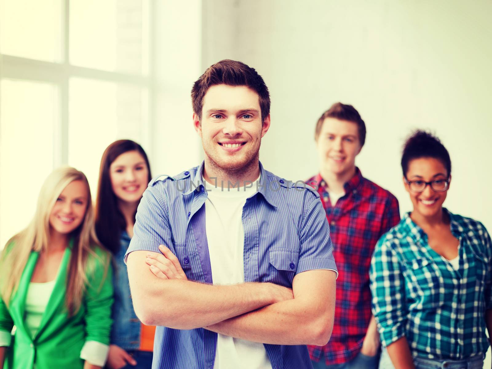 education concept - student boy with group of students at school