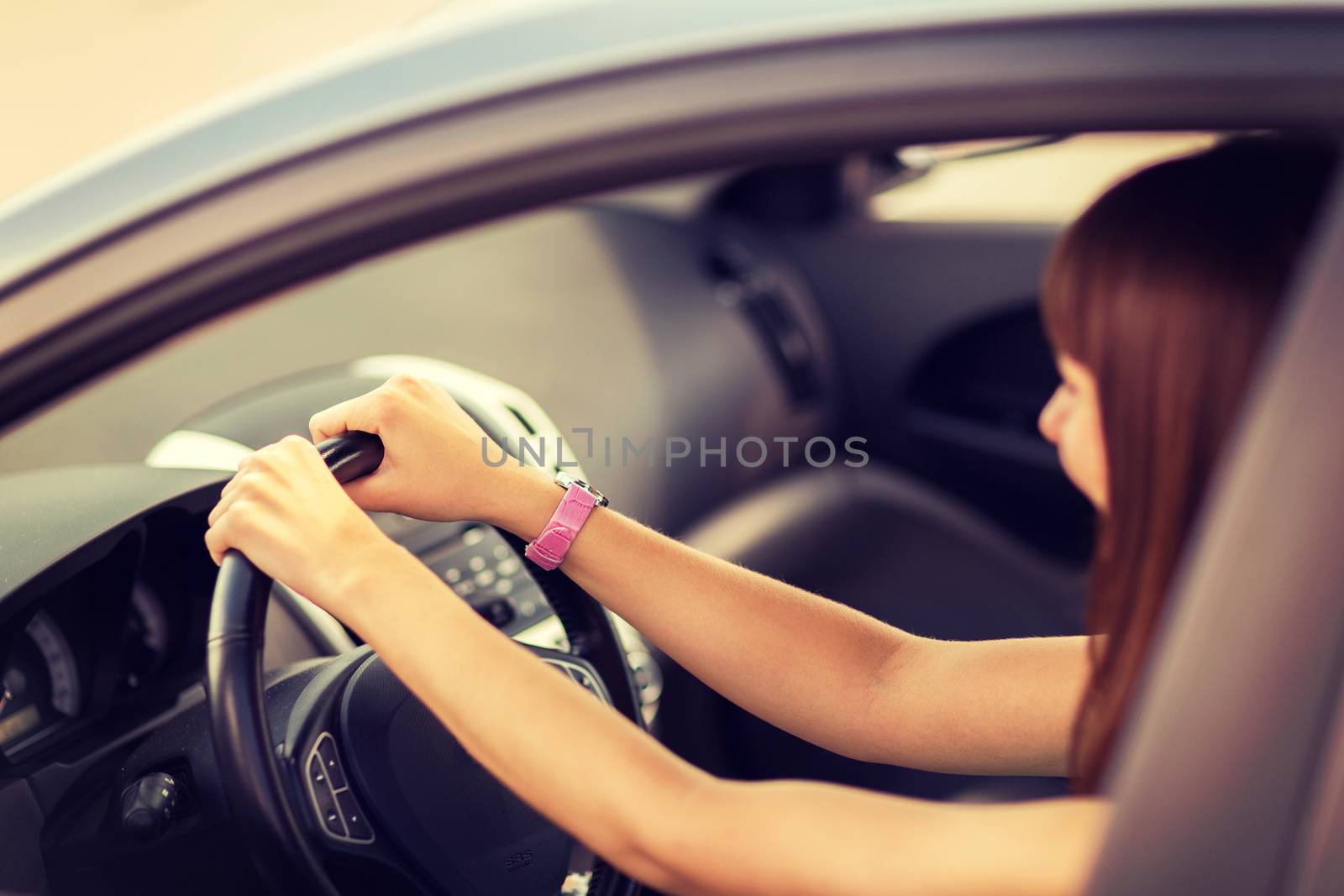 happy woman driving a car by dolgachov