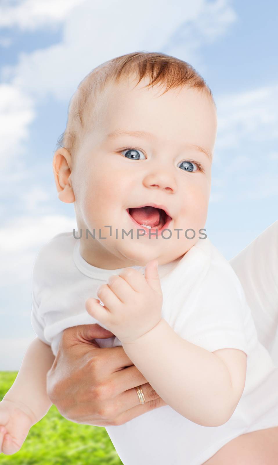 close up of mother holding smiling baby by dolgachov
