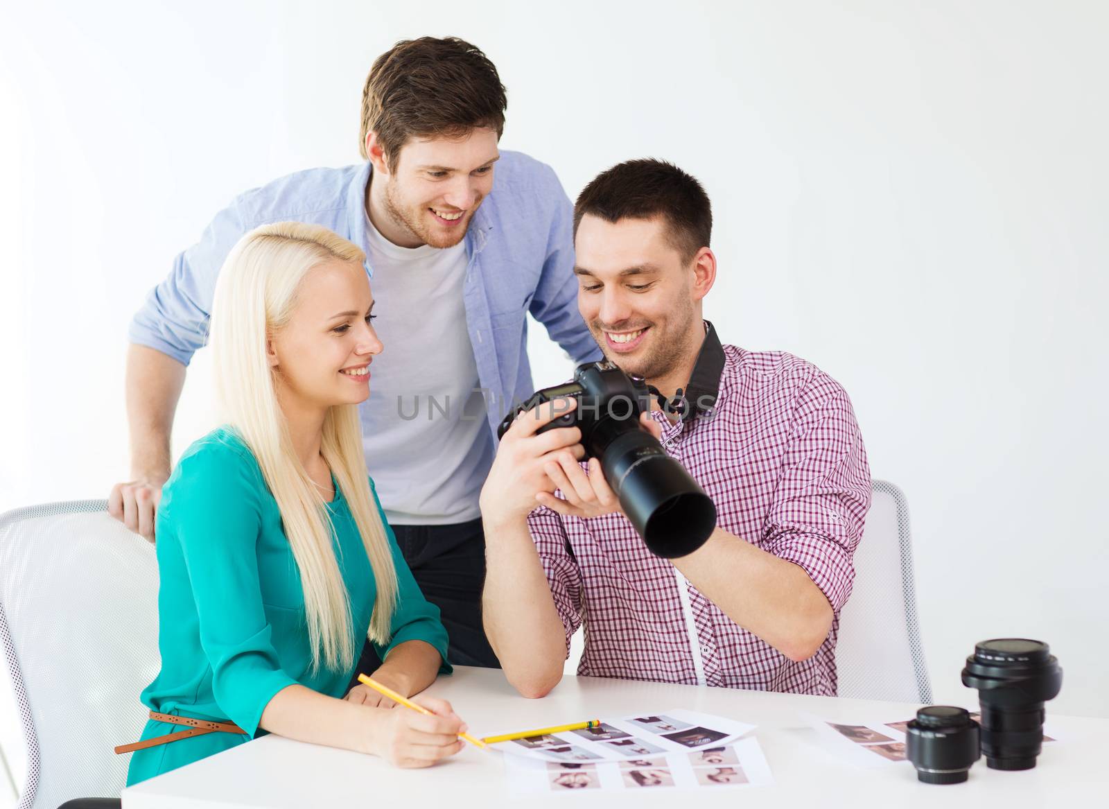 business, education, office and startup concept - smiling creative team with photocamera working in office