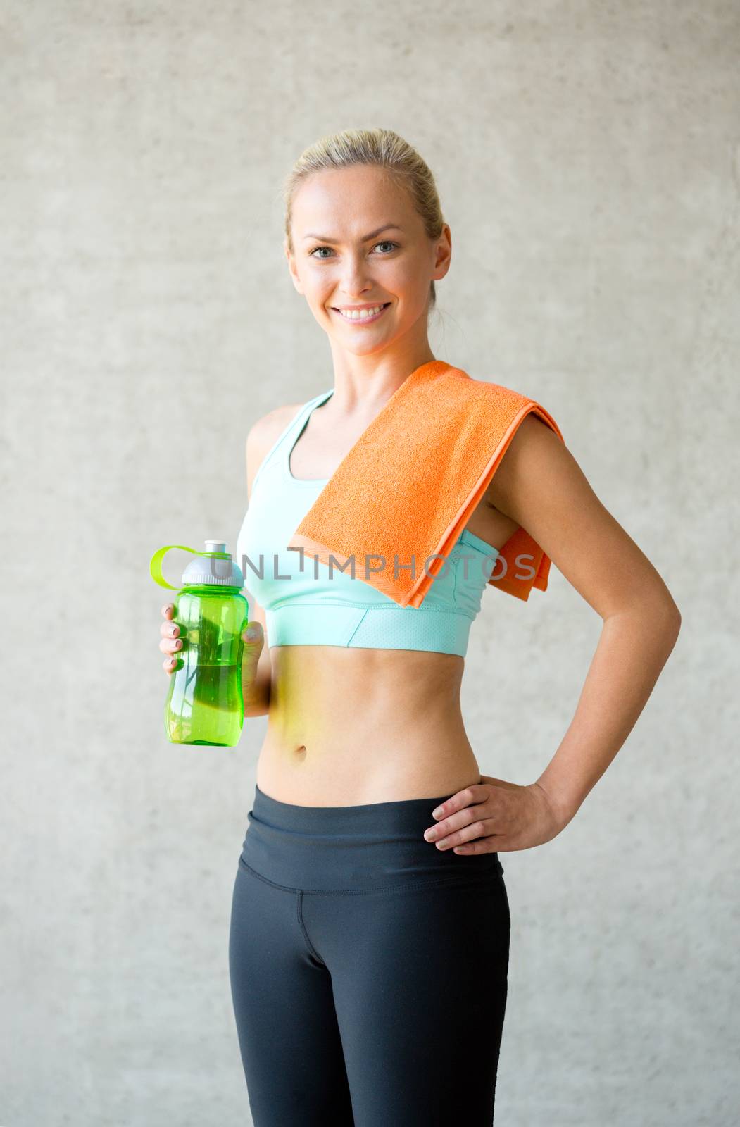 fitness, sport, training, drink and lifestyle concept - woman with bottle of water in gym