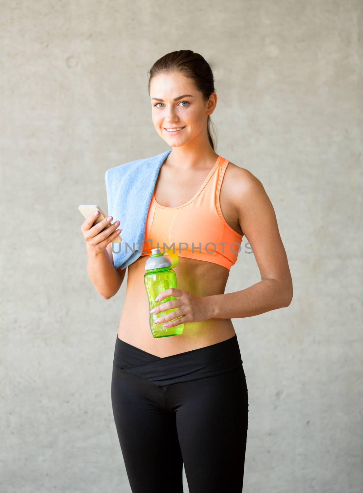 fitness, sport, training, drink and lifestyle concept - woman with bottle of water in gym