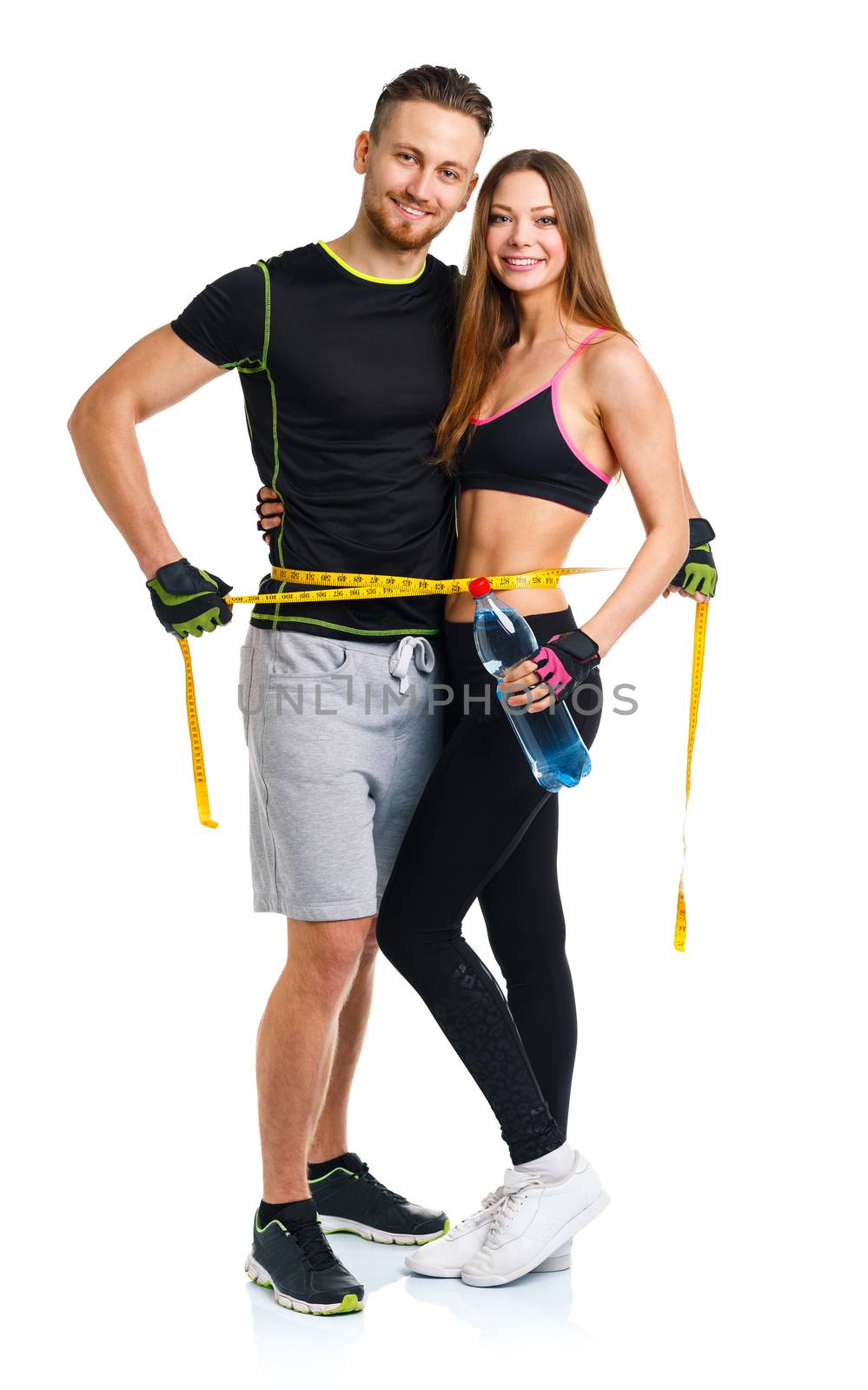 Happy sport couple - man and woman with measuring tape on the wh by vlad_star