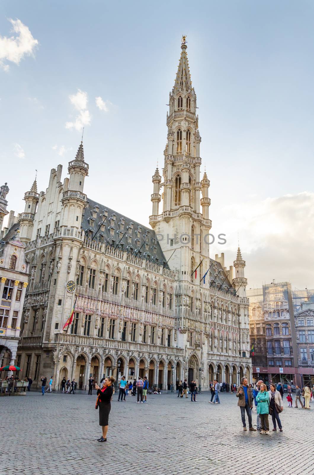 Brussels, Belgium - May 13, 2015: Many tourists visiting famous Grand Place (Grote Markt) the central square of Brussels. by siraanamwong