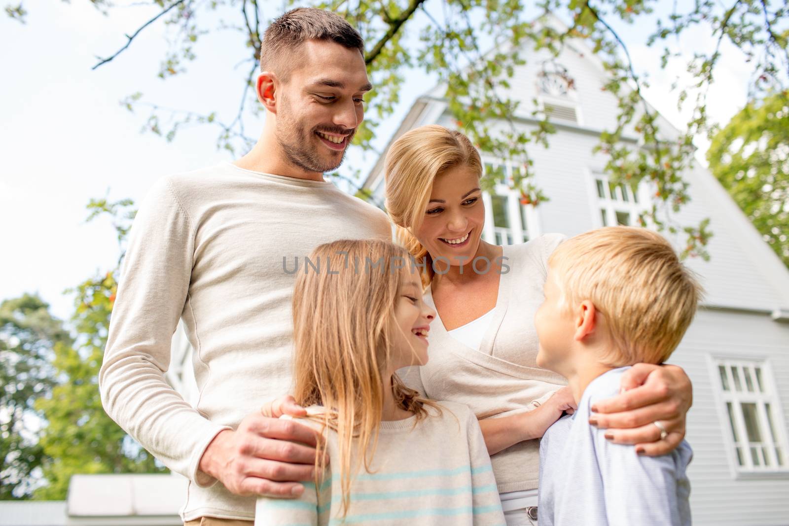 happy family in front of house outdoors by dolgachov