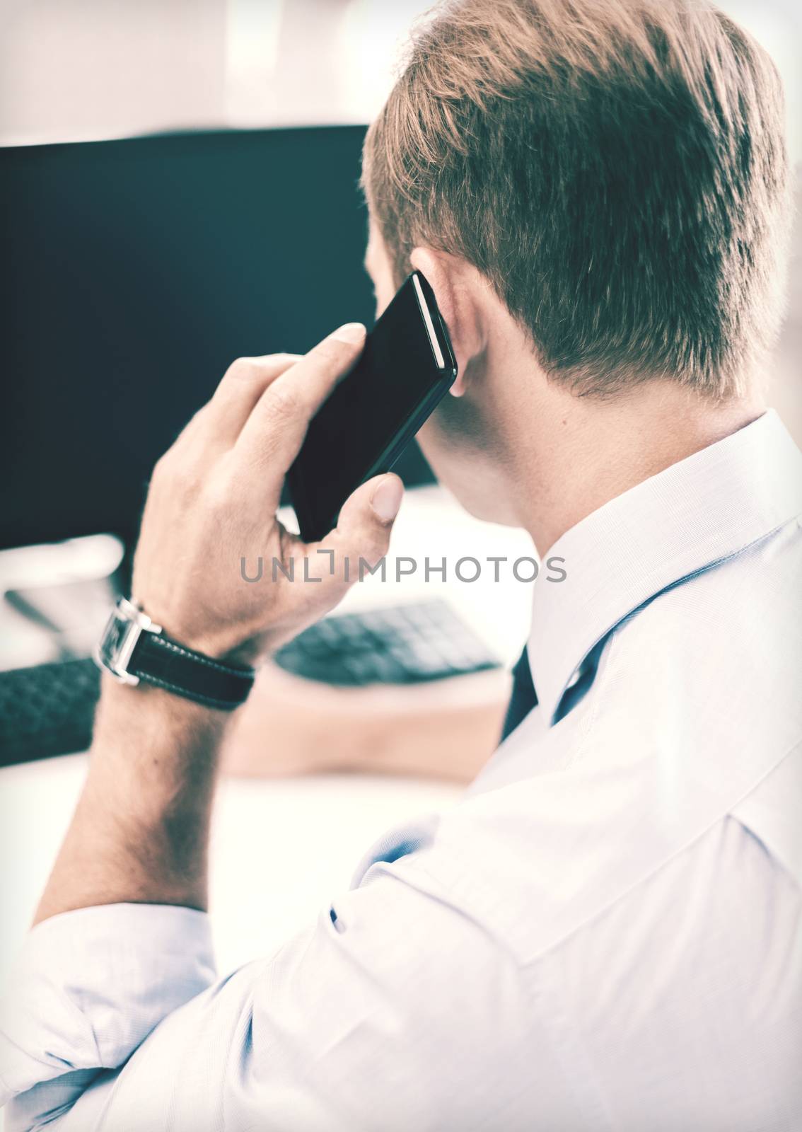 businessman with smartphone in office by dolgachov