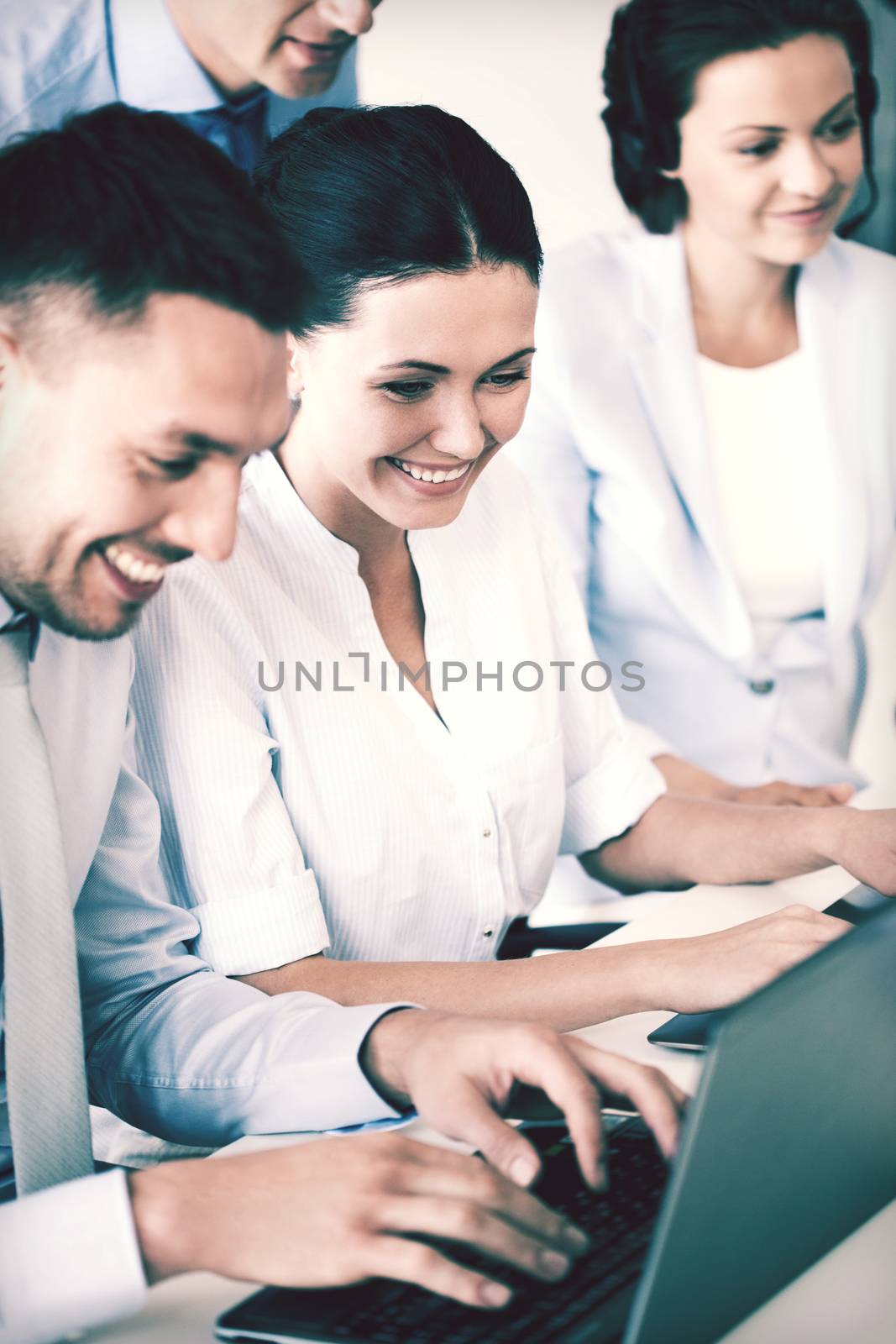 group of people working with laptops in office by dolgachov