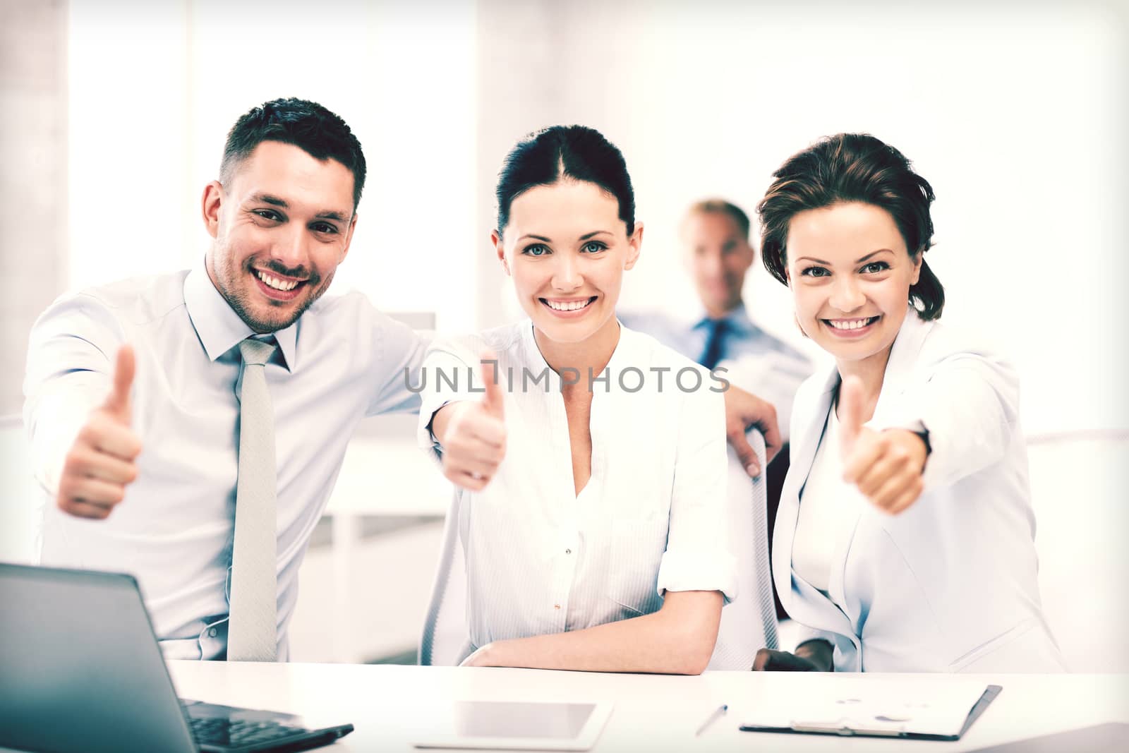 business concept - business team showing thumbs up in office