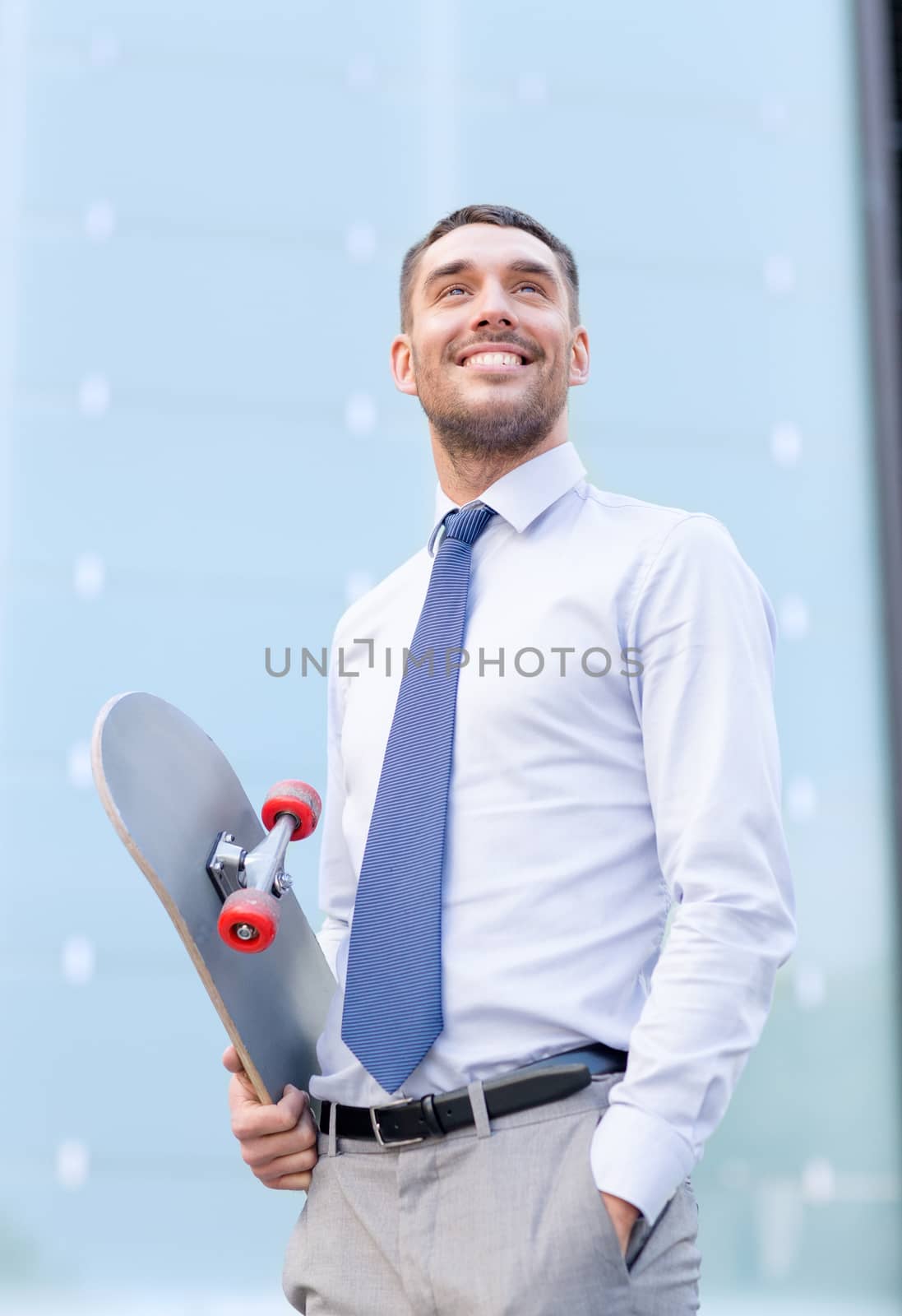 business, hot drinks and people and concept - young smiling businessman with skateboard outdoors