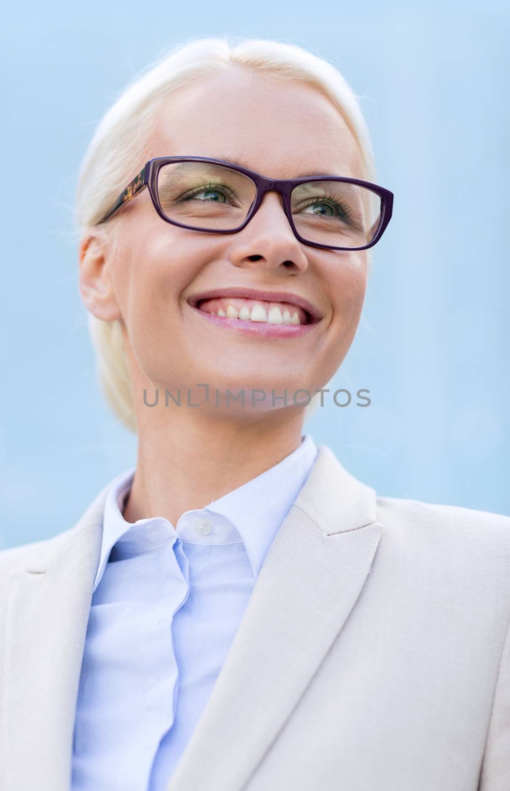 young smiling businesswoman over office building by dolgachov