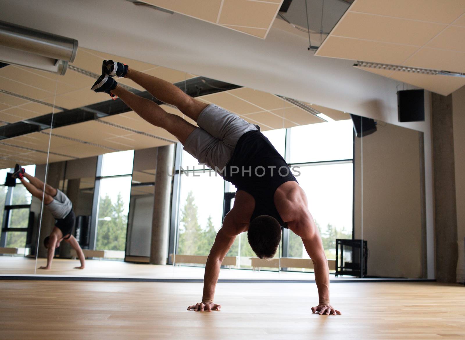 sport, fitness, lifestyle and people concept - man exercising in gym