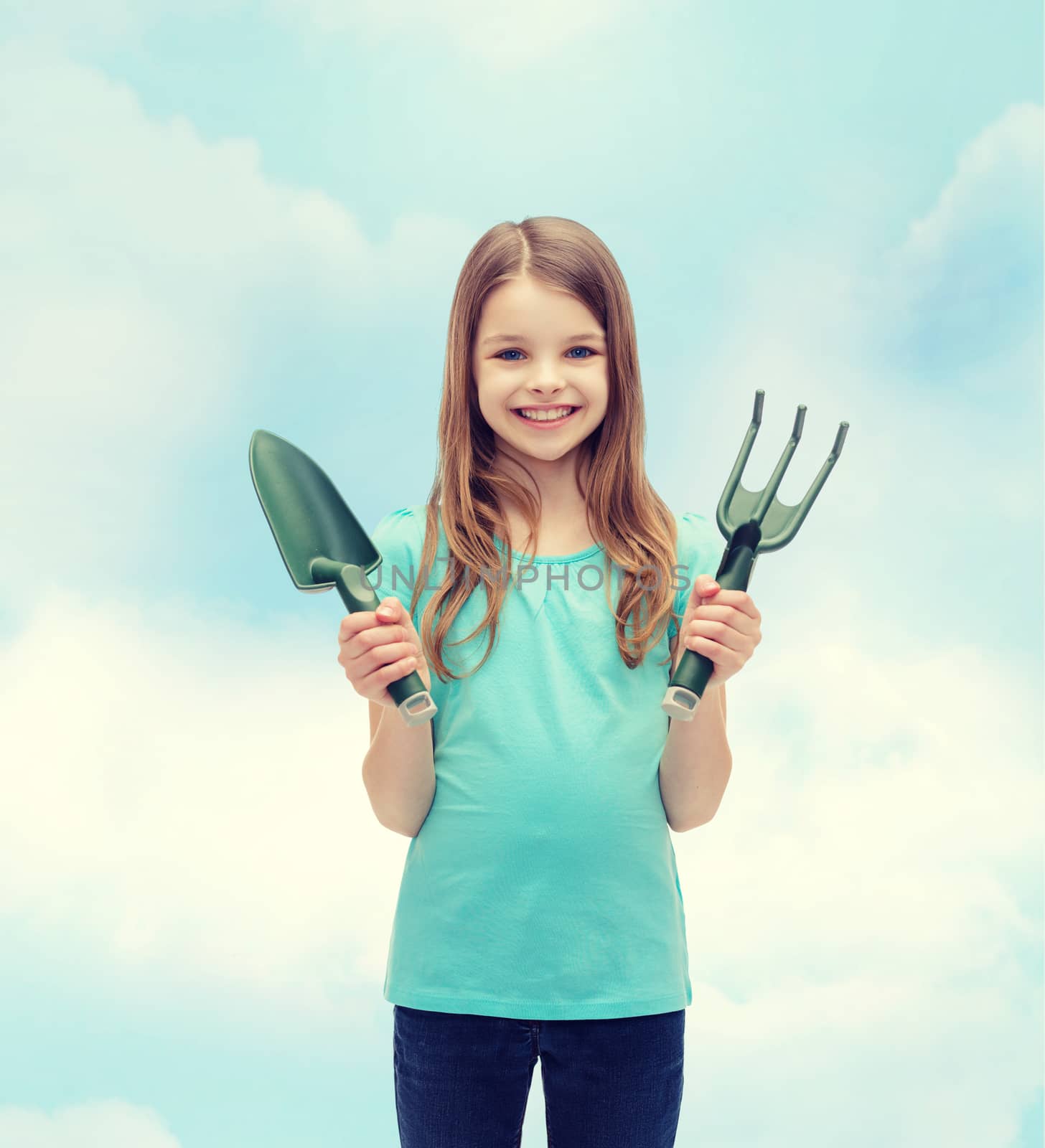 smiling little girl with rake and scoop by dolgachov