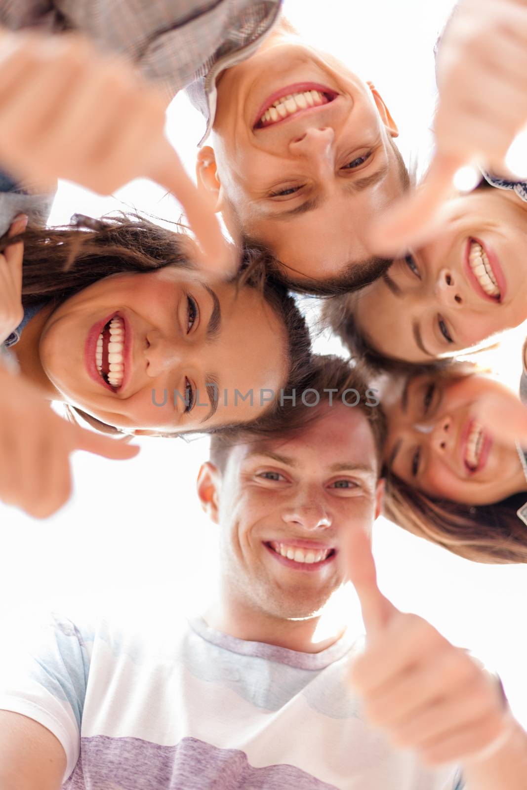 group of smiling teenagers looking down by dolgachov