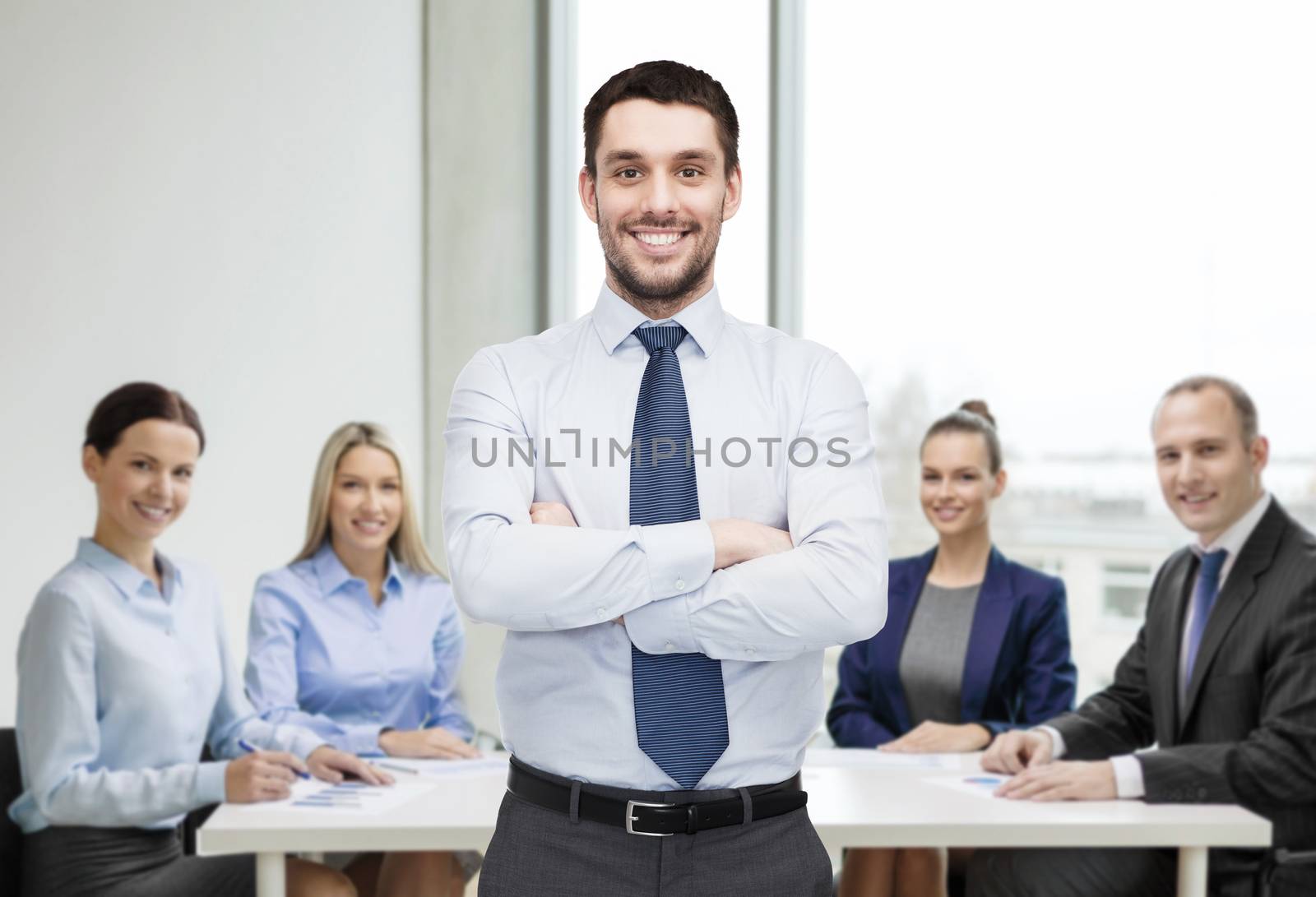 handsome businessman with crossed arms by dolgachov